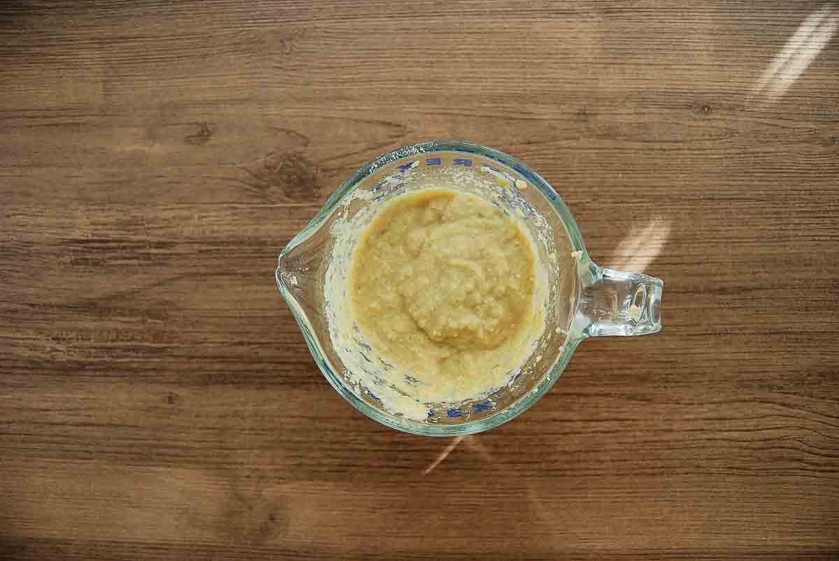 A glass measuring cup filled with a panade for meatloaf.