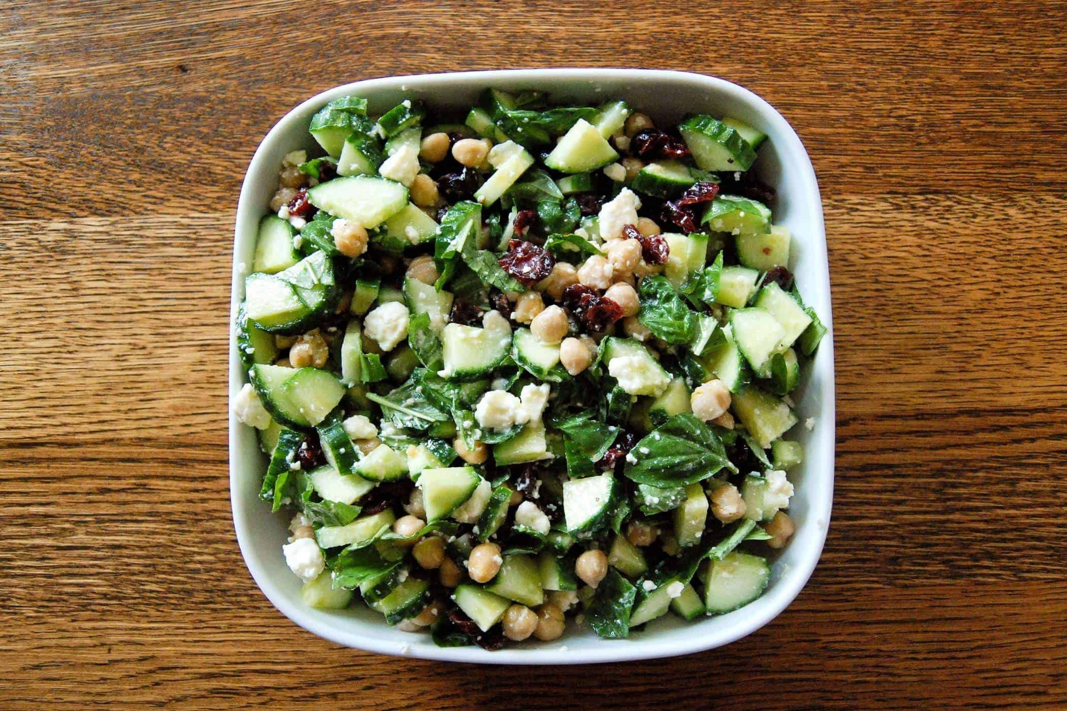 cucumber salad with chickpeas in bowl on table.