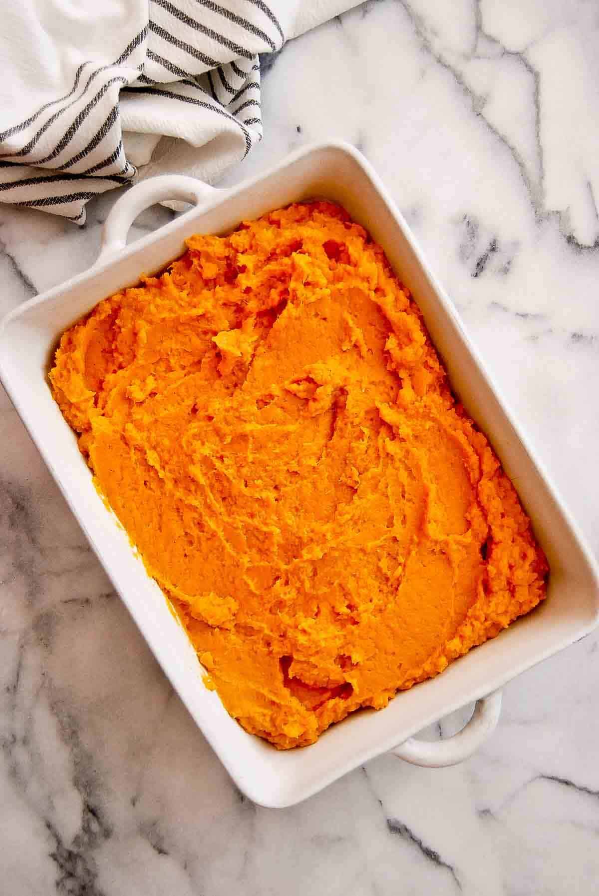 Mashed sweet potato mixture in casserole dish.