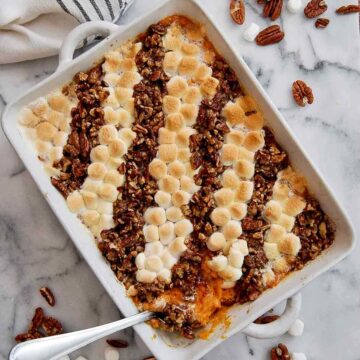 old fashioned sweet potato casserole with serving spoon in casserole dish.