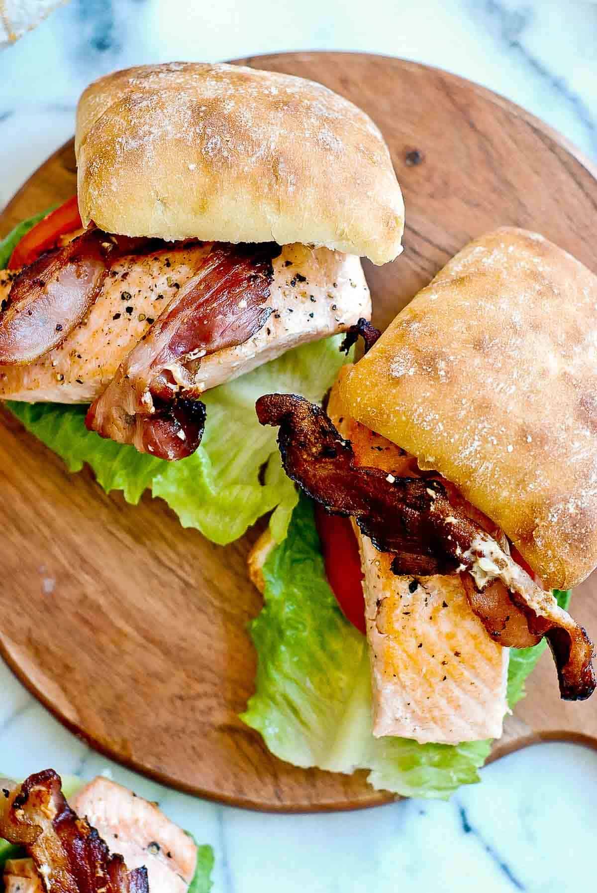 salmon blt sandwiches on ciabatta buns.