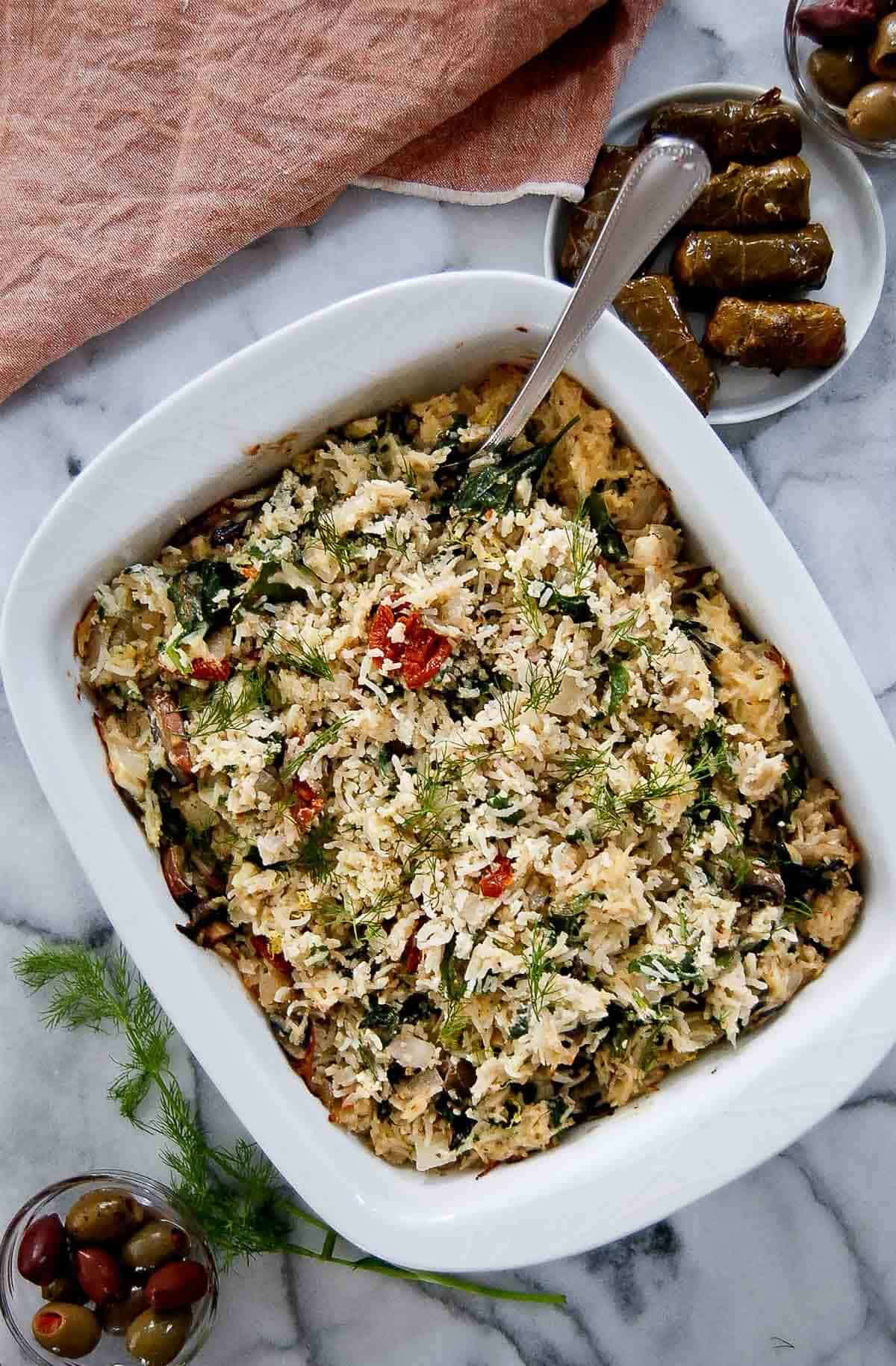 spinach feta and rice casserole in serving dish on counter.