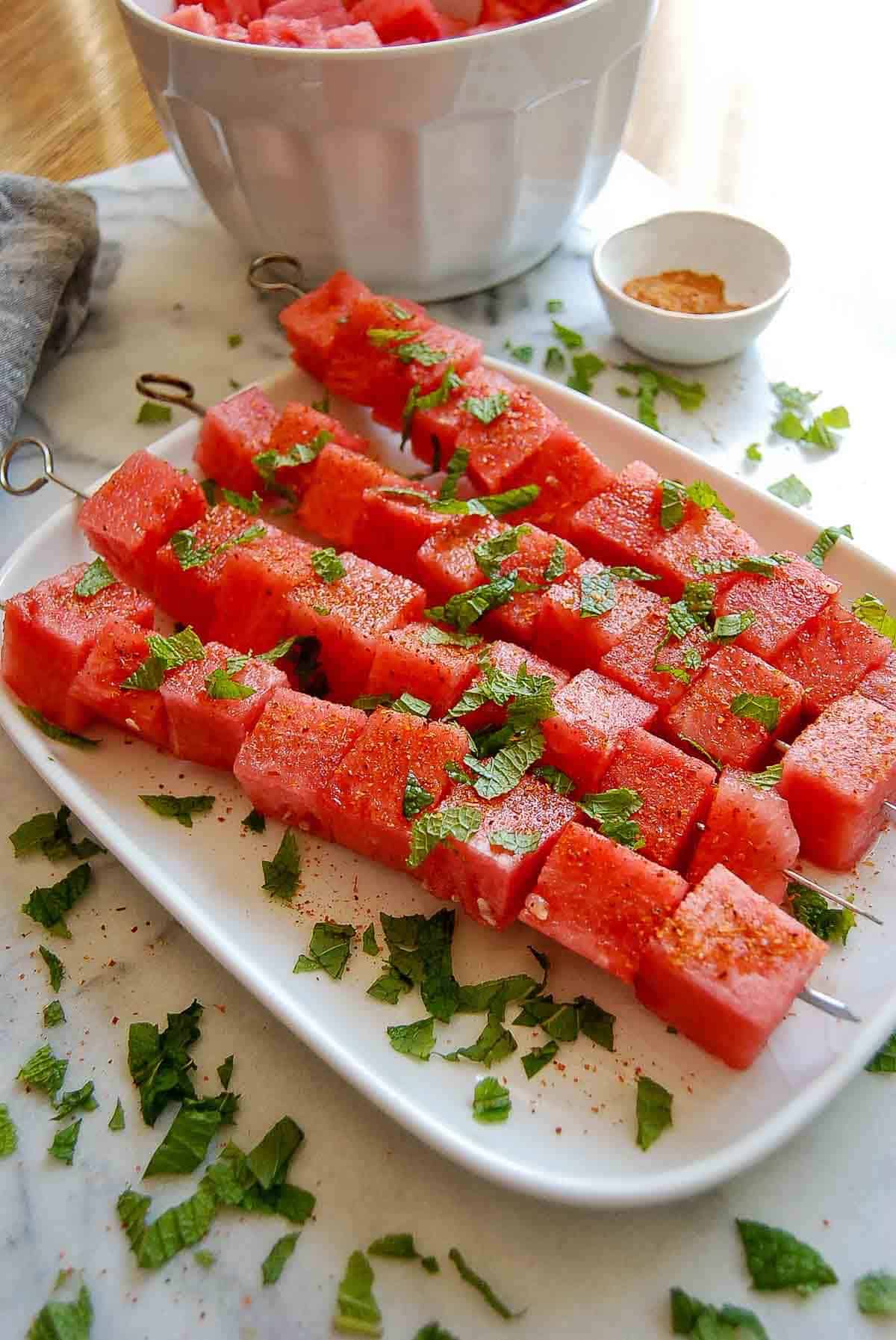 watermelon with tajin and mint on plate.