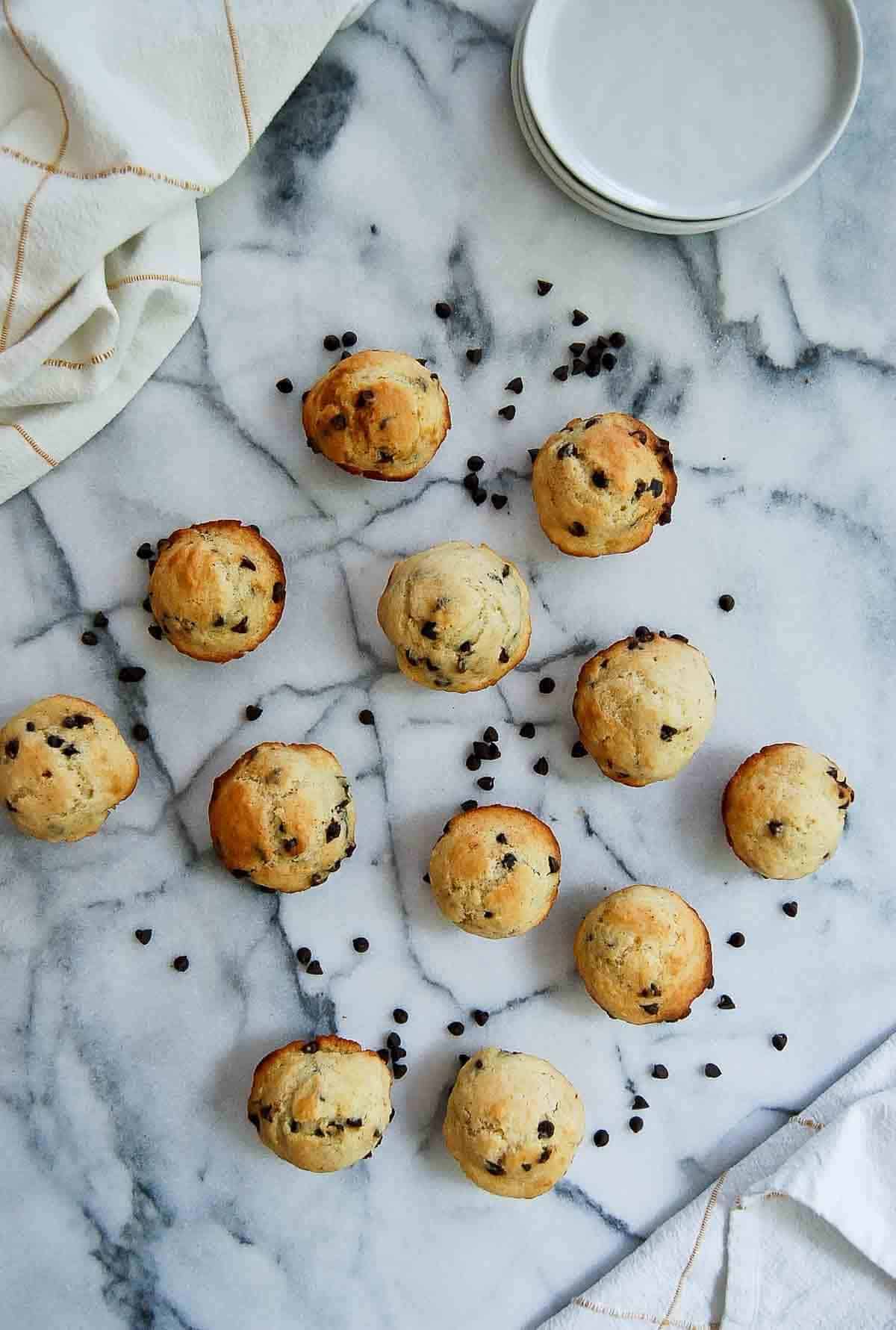 moist chocolate chip mini muffins lined on countertop.