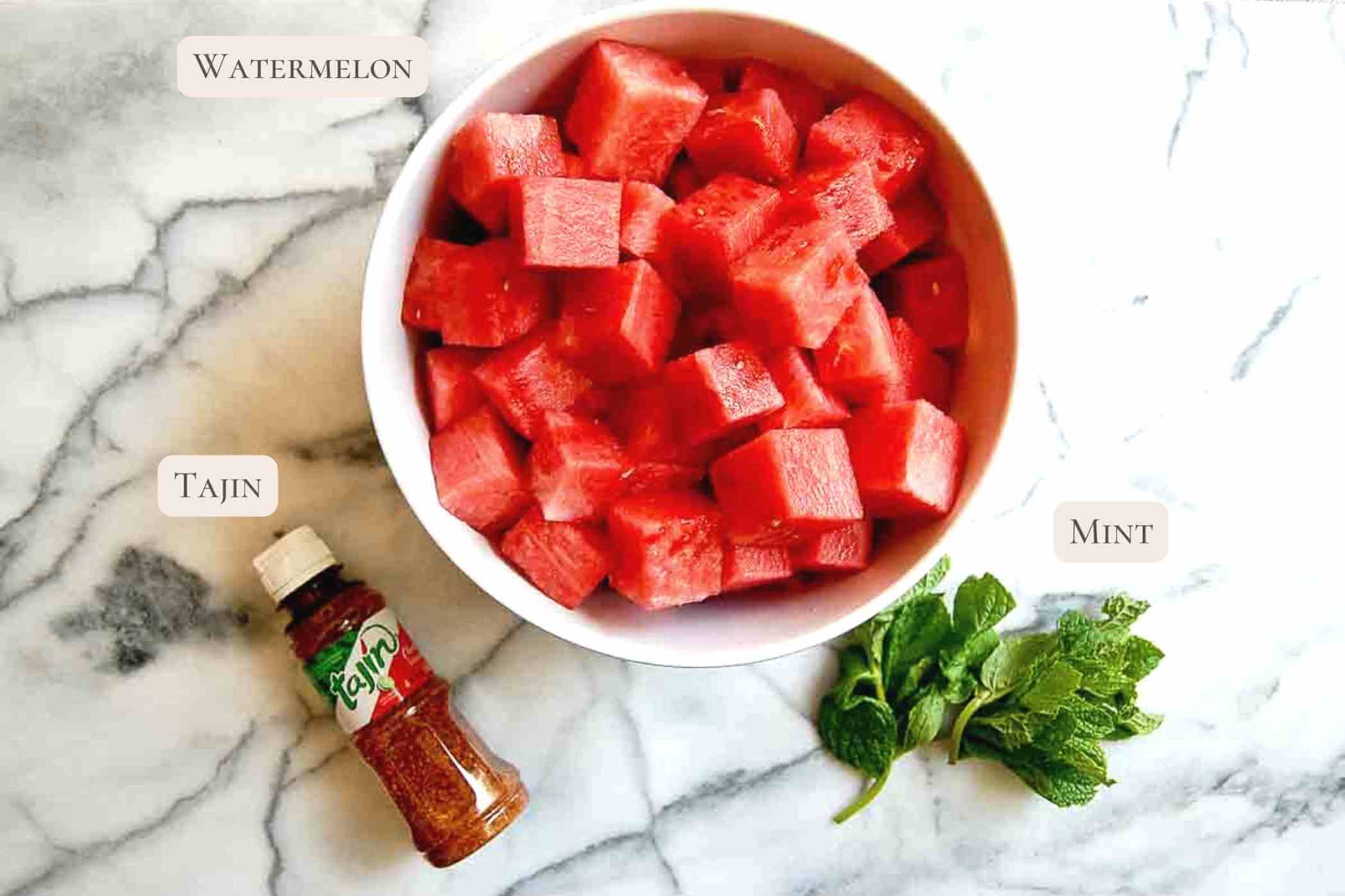 ingredients for tajin watermelon on cutting board.