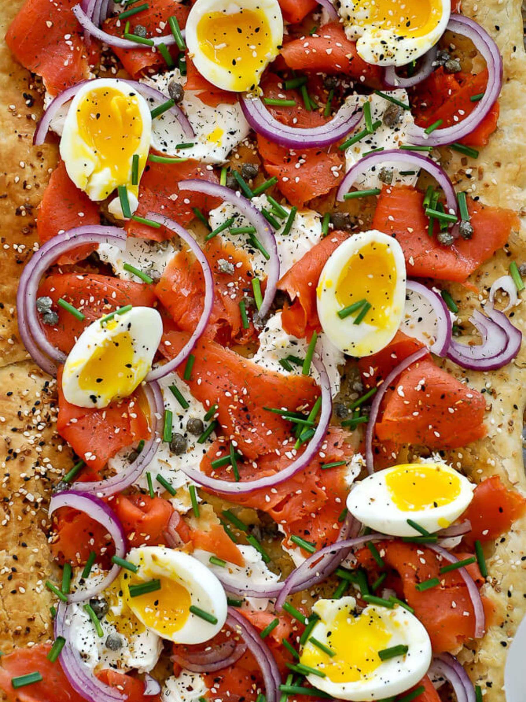 Closeup of smoked salmon pizza with soft eggs.