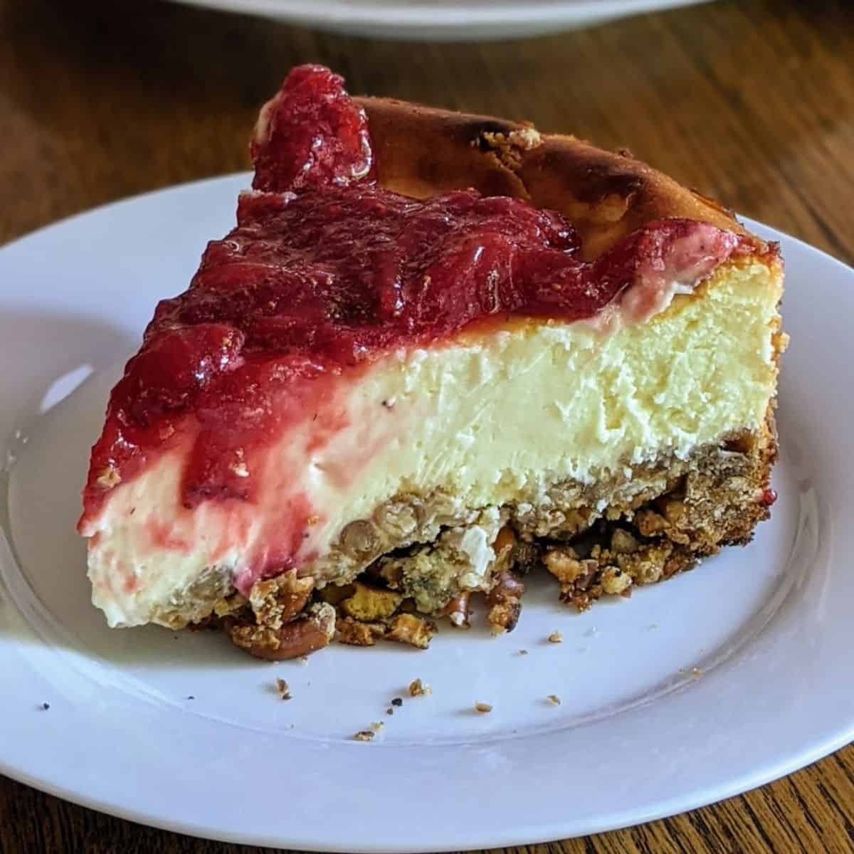 Closeup view of strawberry cheesecake with a pretzel crust - slice.