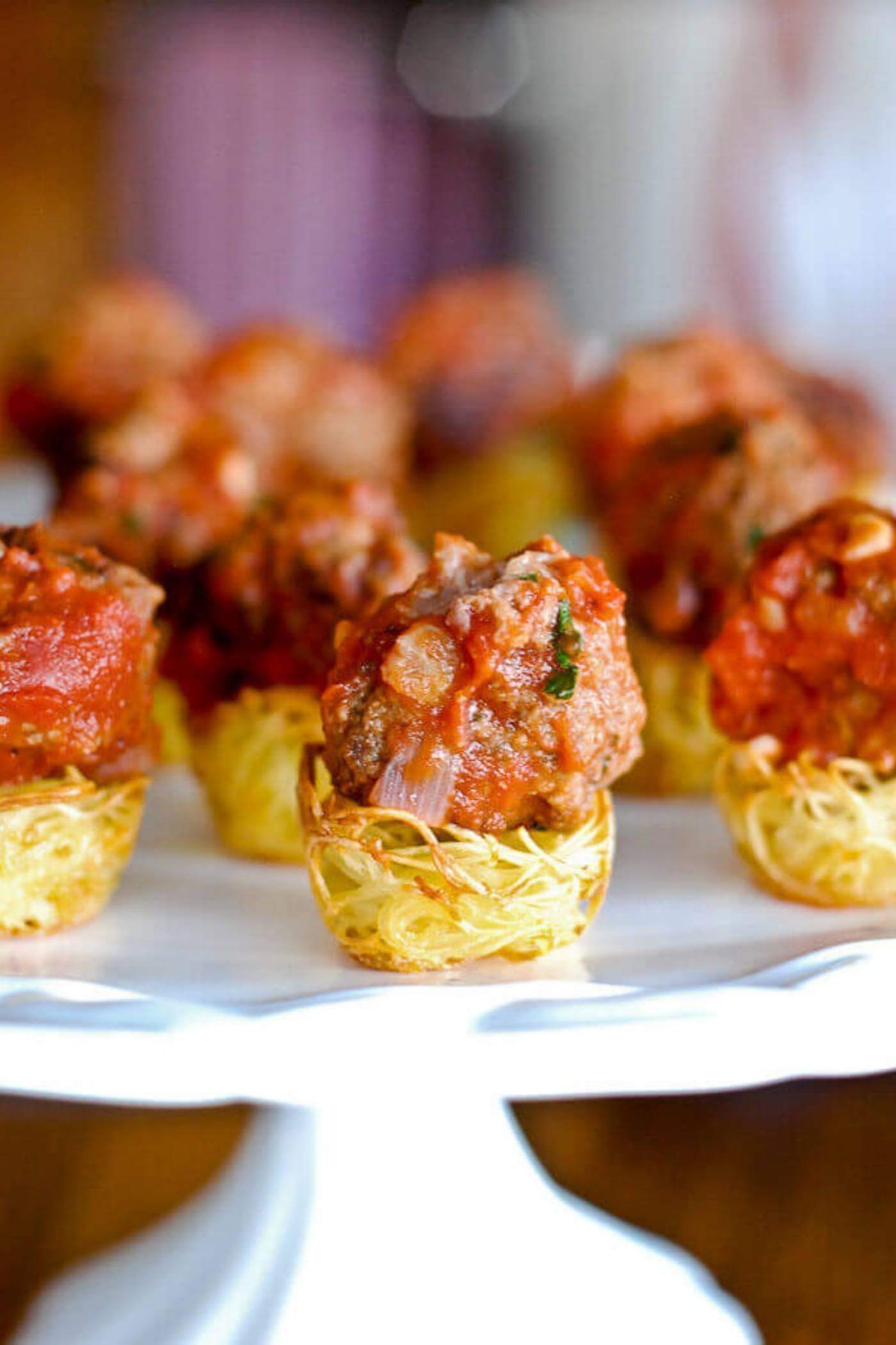 baked pasta nest with meatball on serving platter.