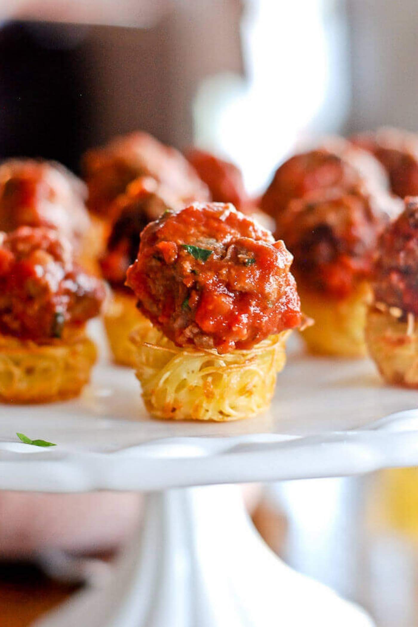 baked pasta nest with meatball on serving platter.