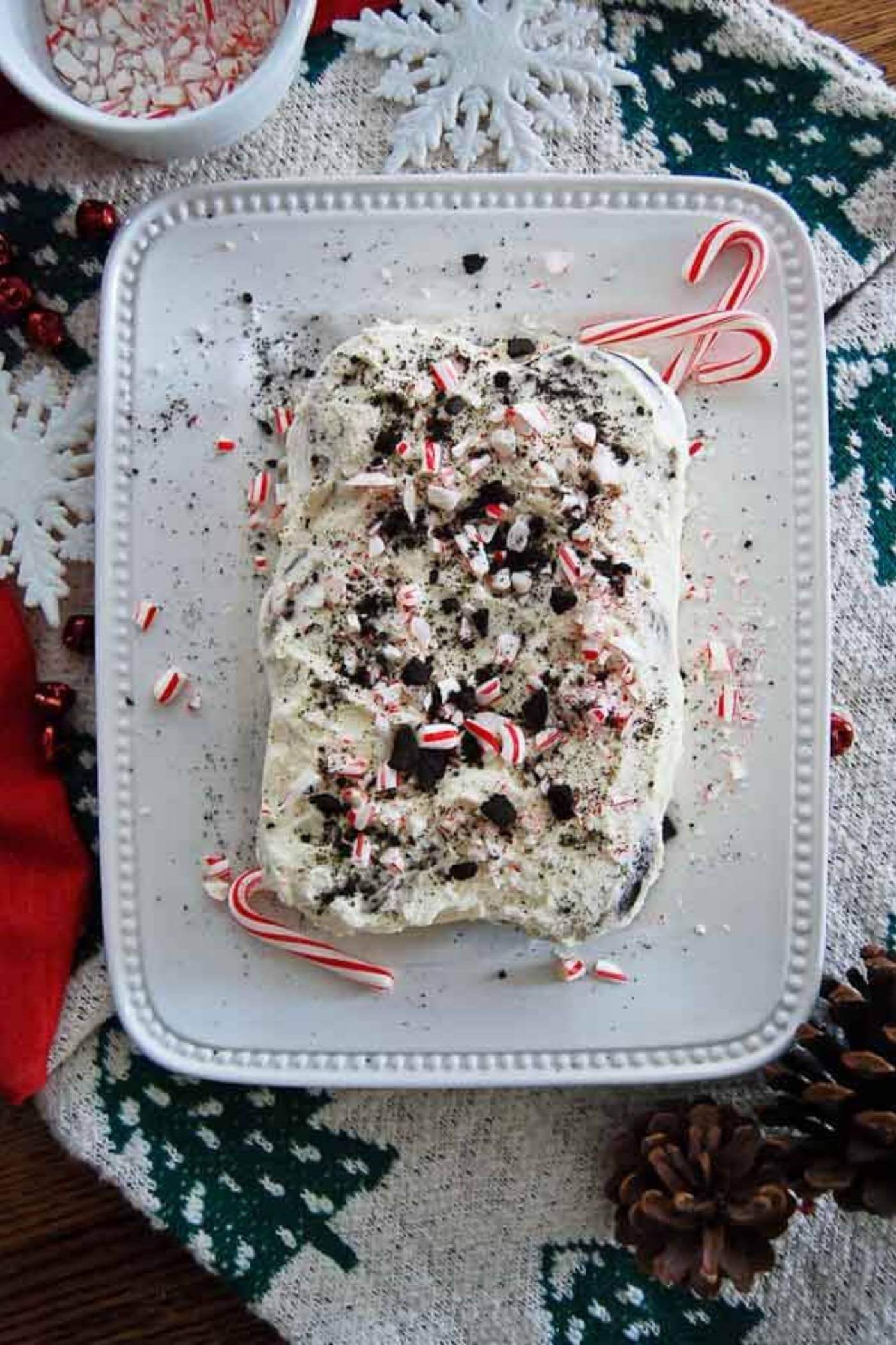 chocolate and peppermint icebox cake on plate with candy canes.