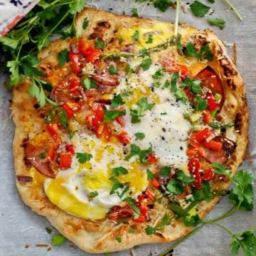 breakfast pizza on parchment paper