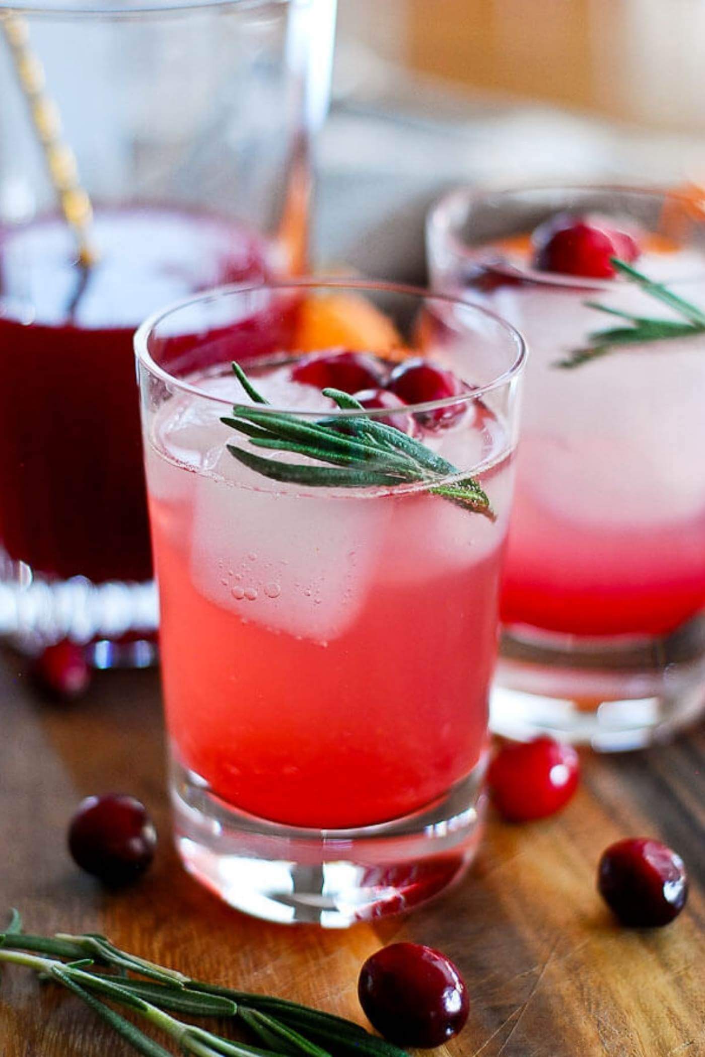 cranberry orange and rosemary shrub mocktail in glass.