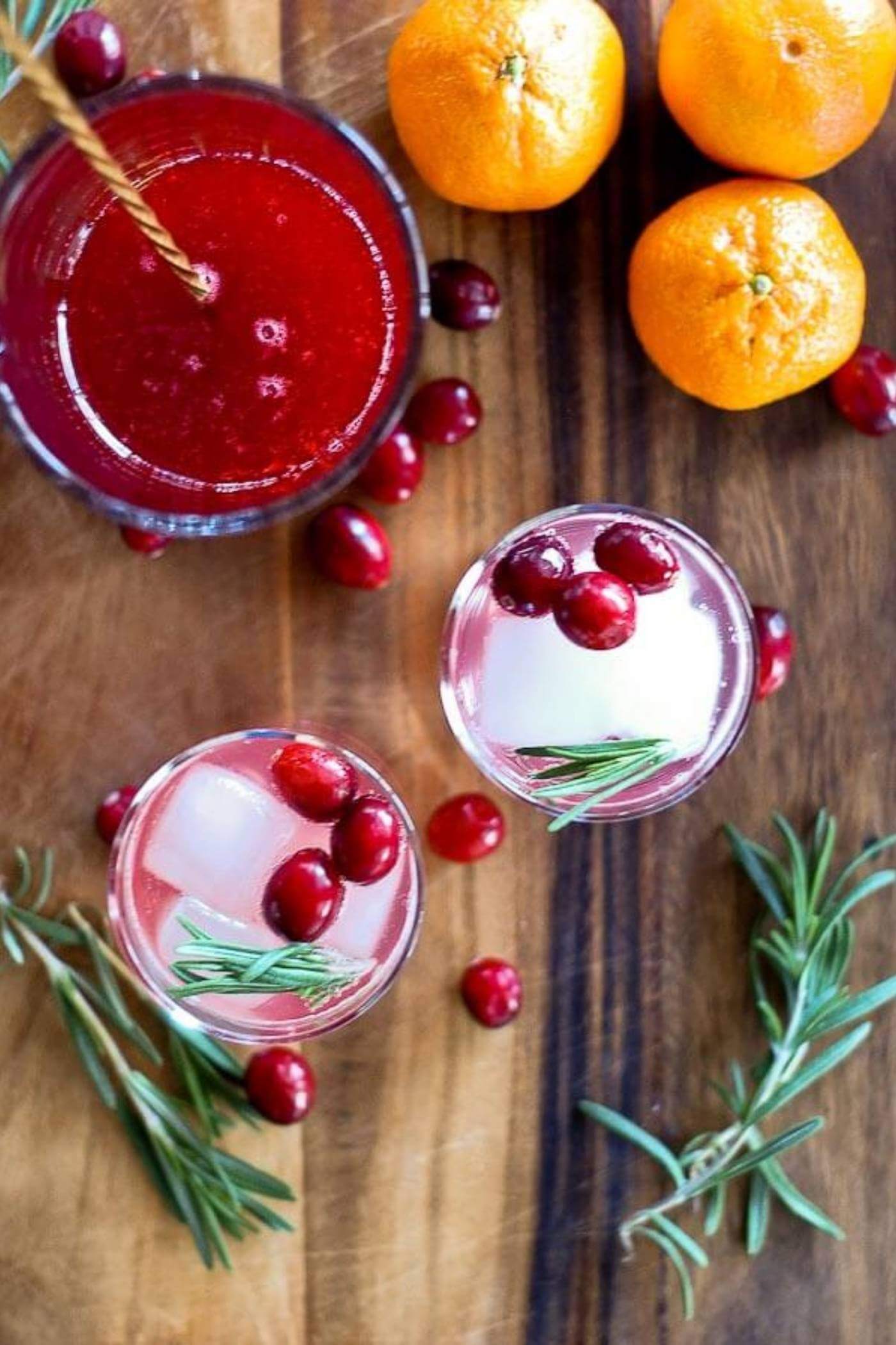 cranberry orange and rosemary shrub mocktail in glass view from above.