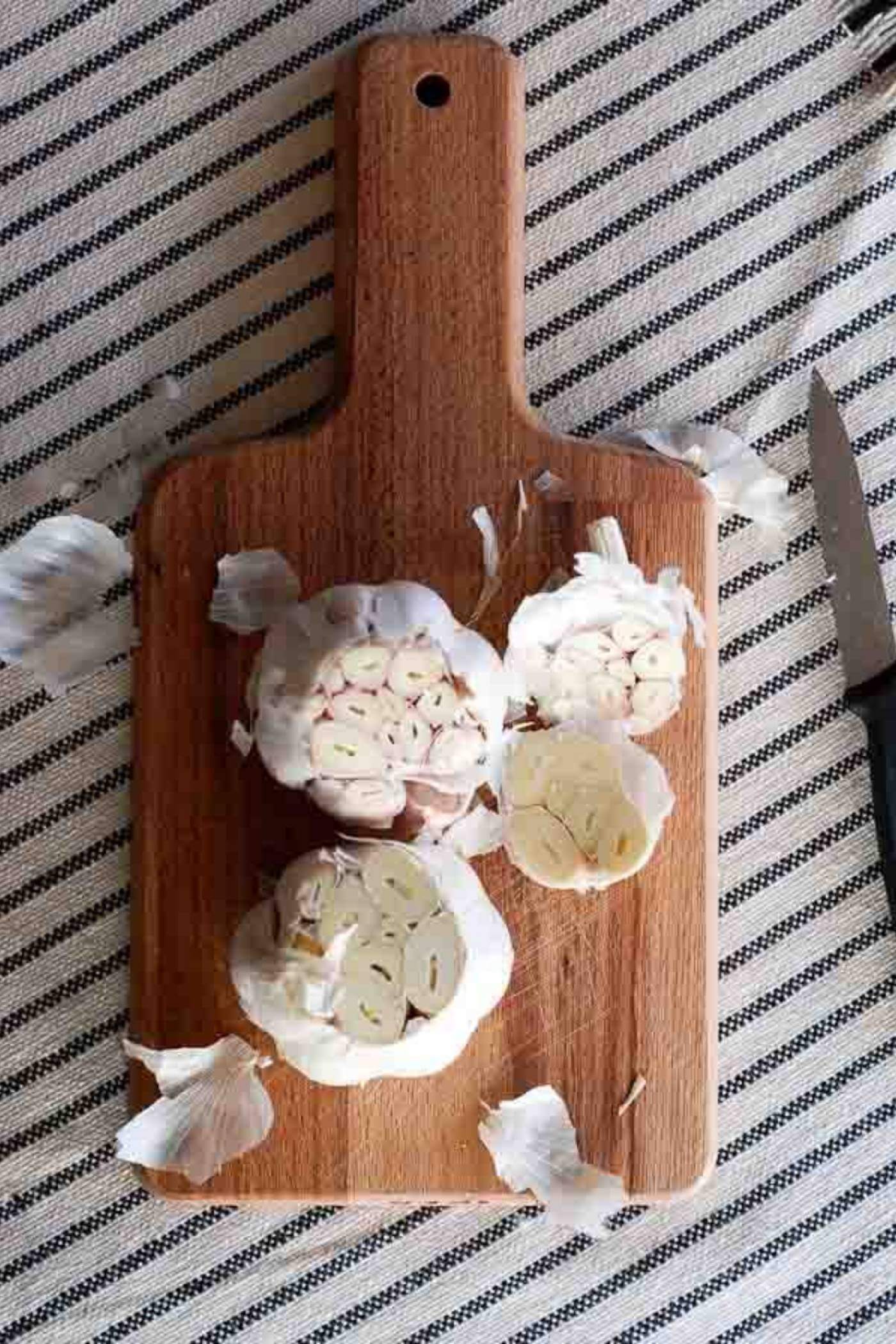 garlic bulbs on cutting board.