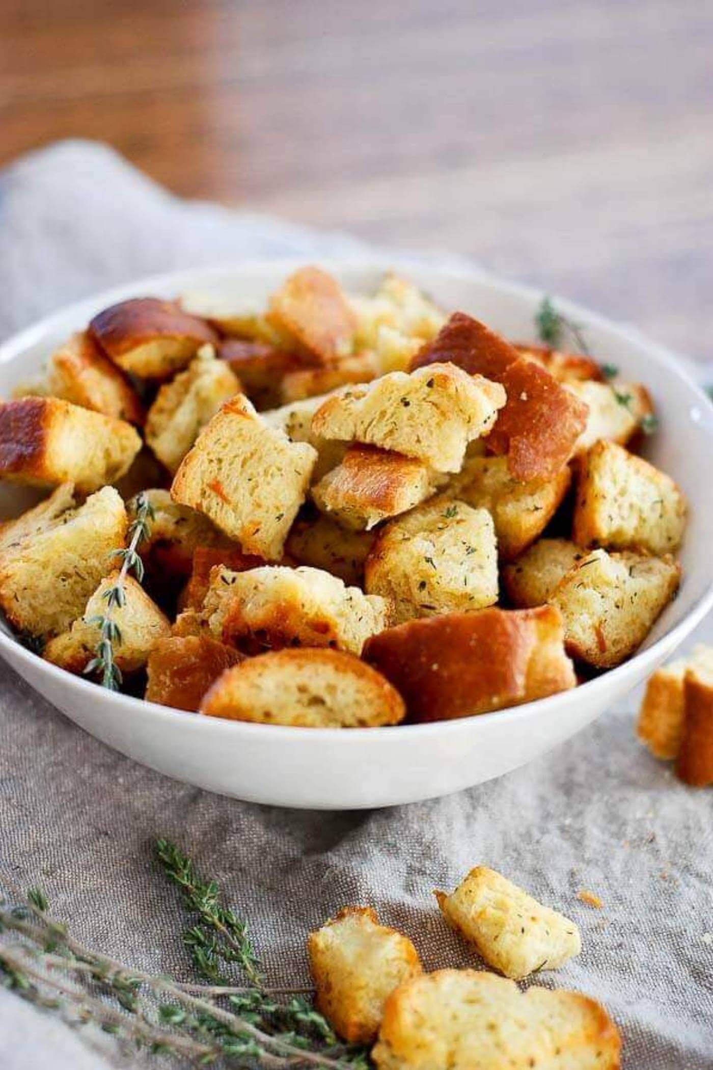 croutons piled high in bowl sprinkled with thyme.