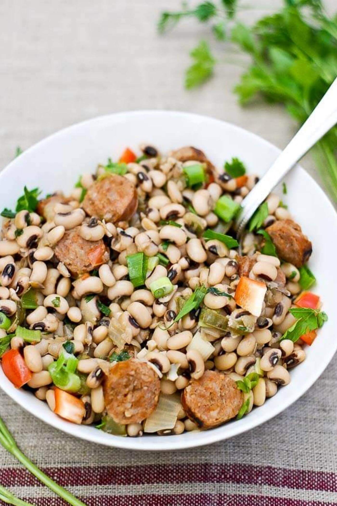 Bowl of hoppin' john with black eyed peas and sausage.