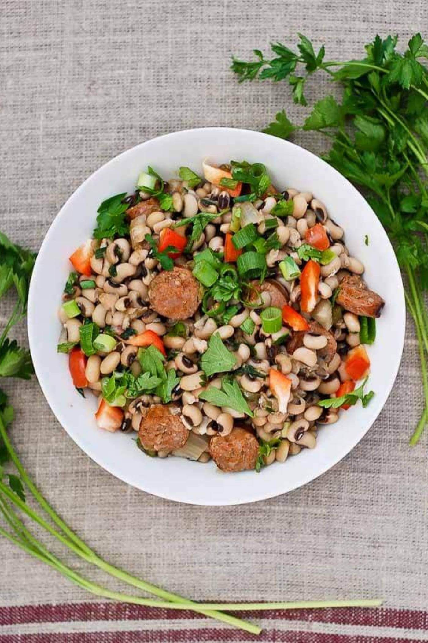 Bowl of hoppin' john with black eyed peas and sausage.