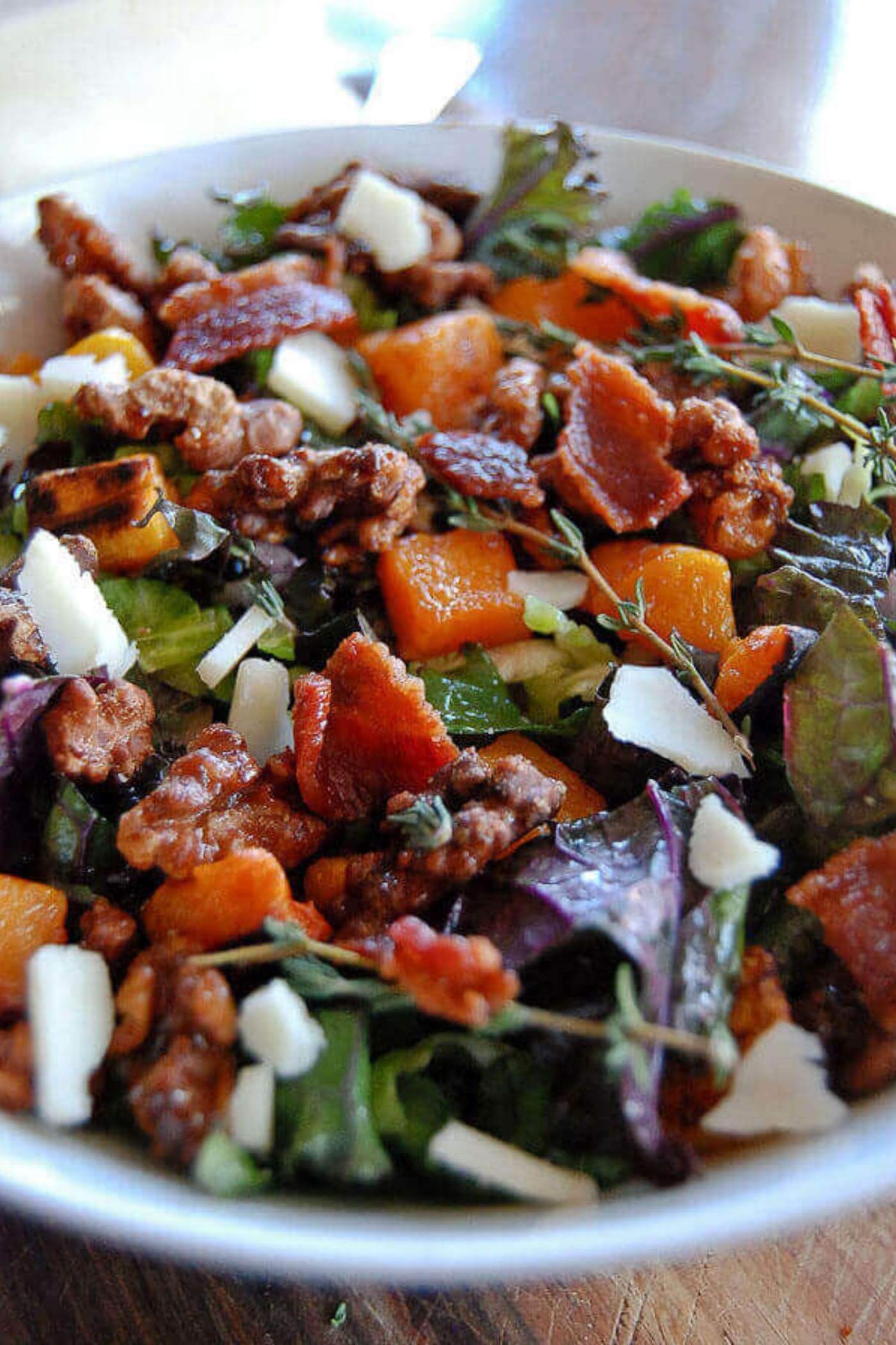 close up of kale salad with shaved brussels sprouts and butternut squash.