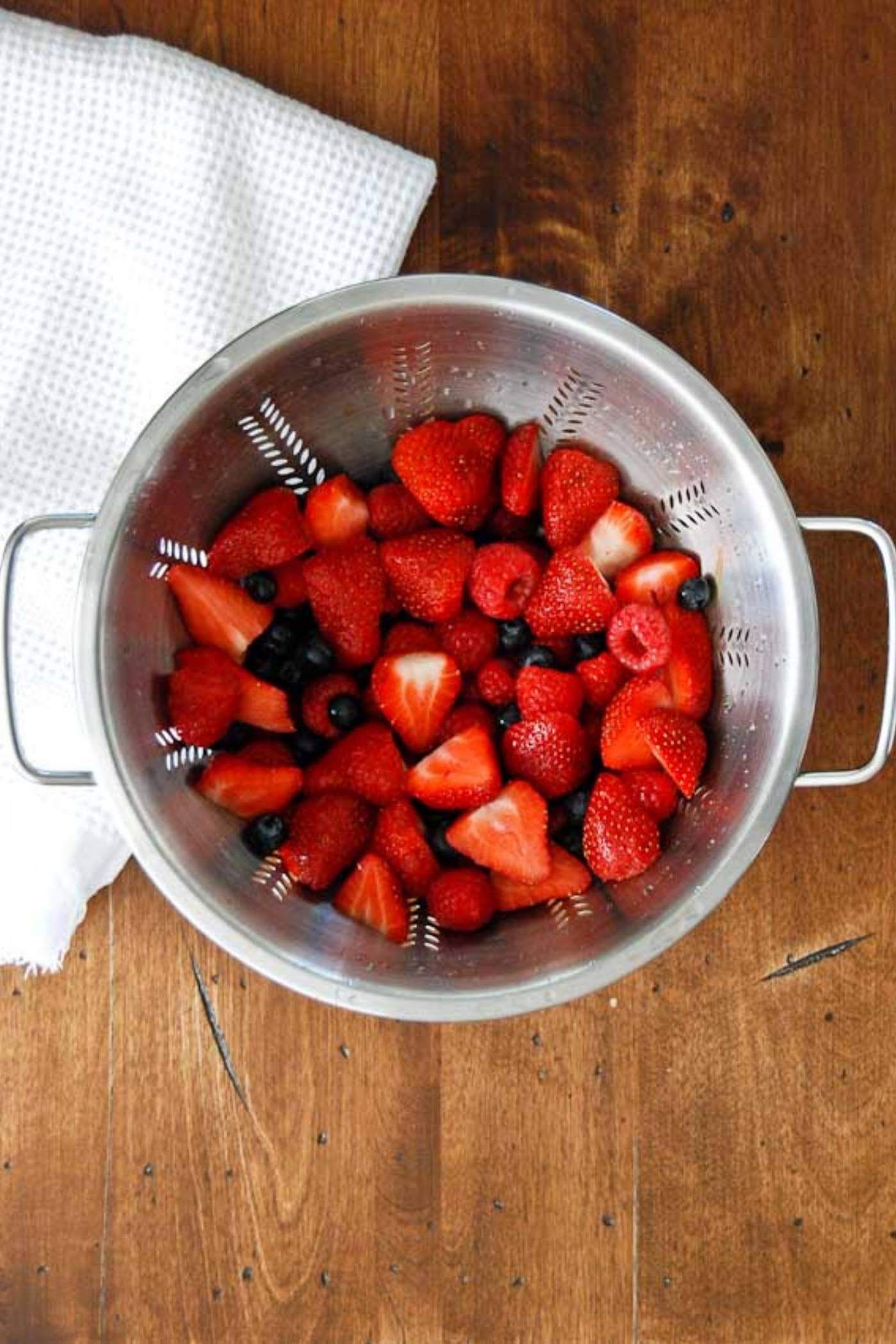 mixed berries in a colander. 