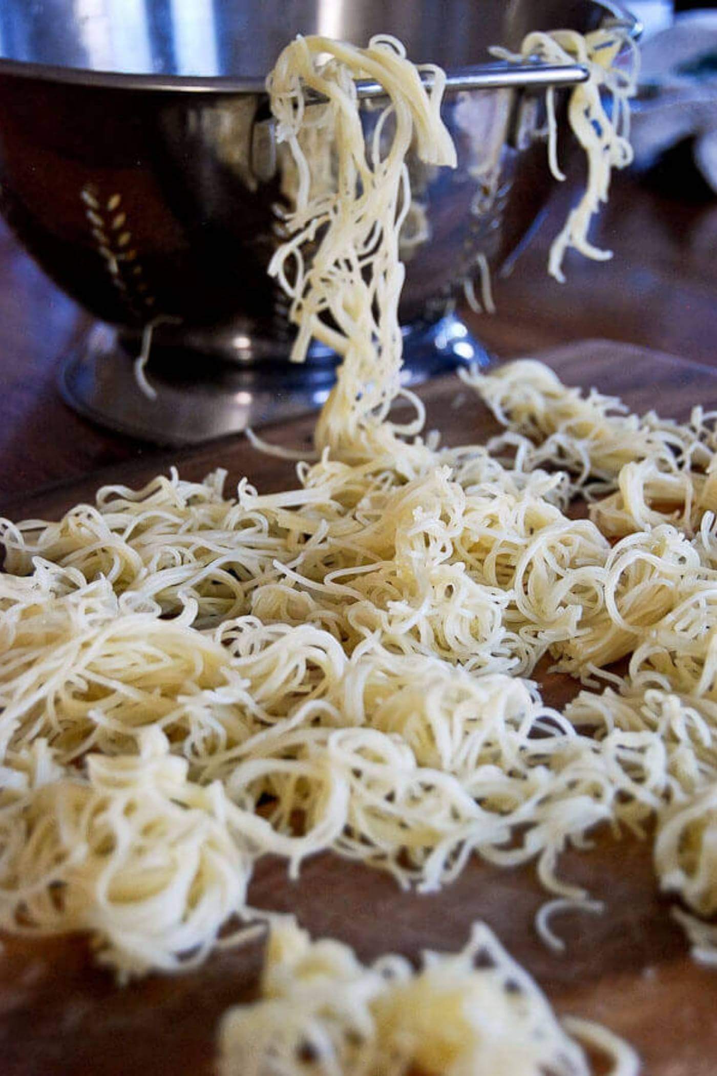 boiled pasta on table and in colander.