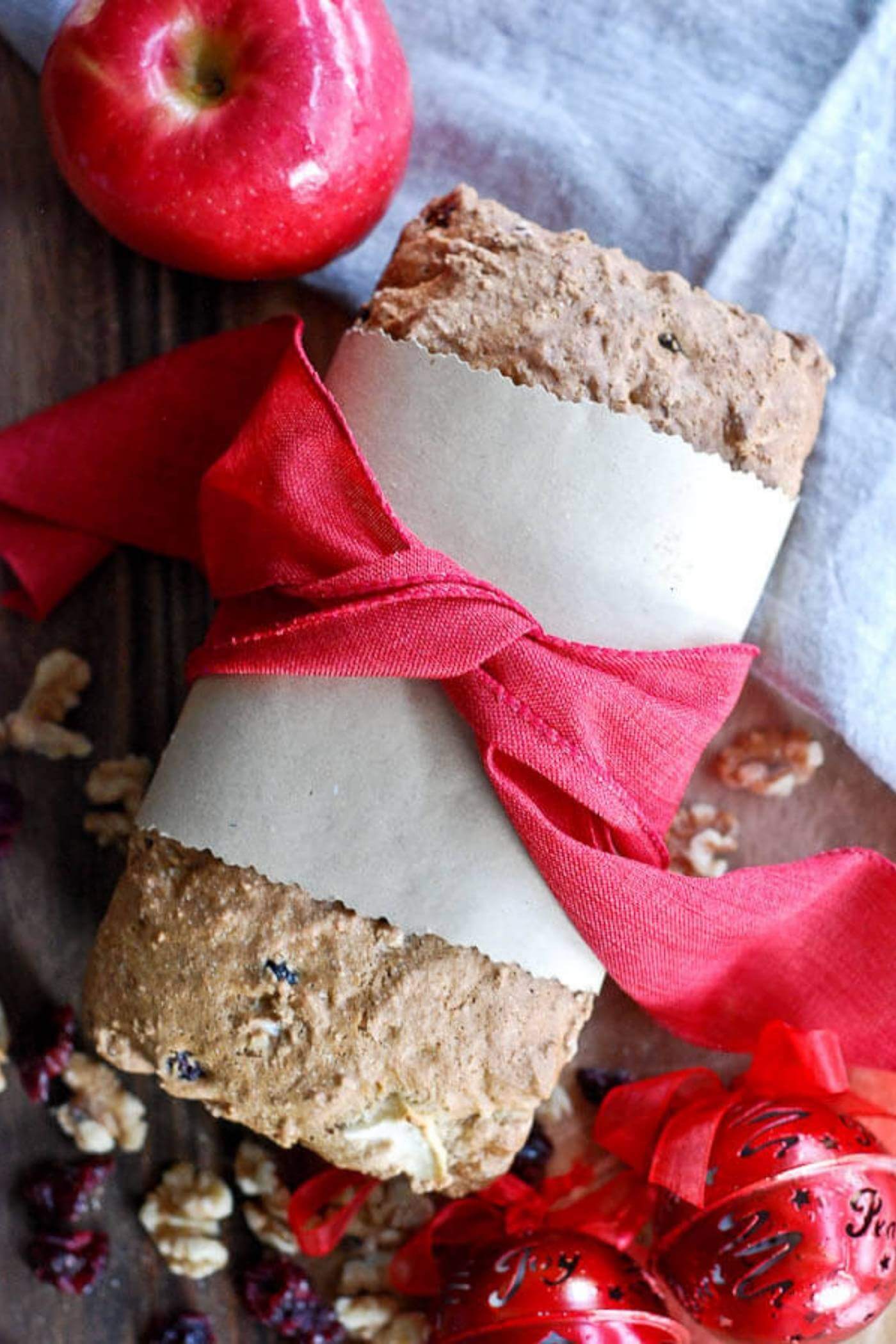 apple cranberry and walnut quick bread on cutting board.