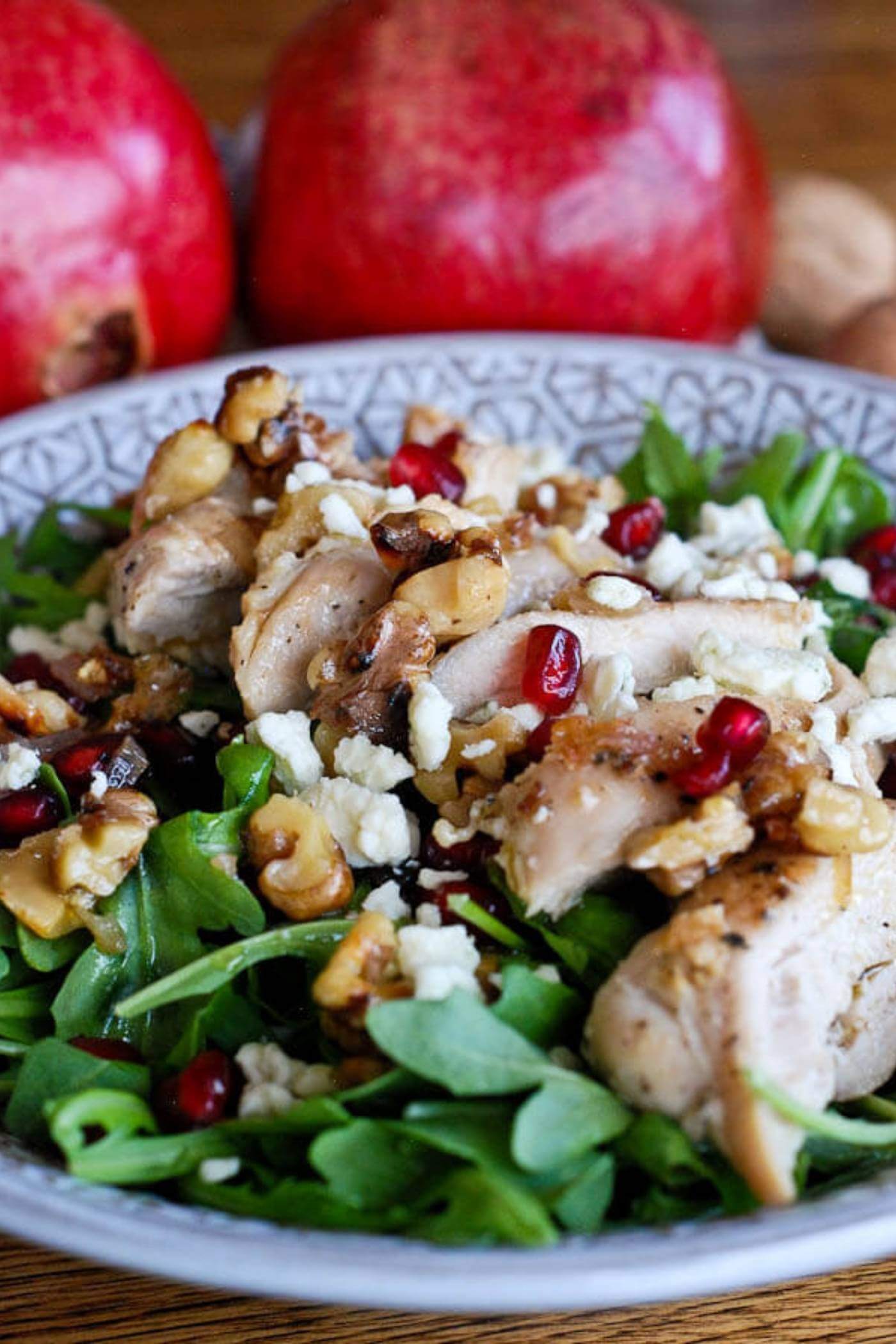 chicken pomegranate and arugula crunch salad in bowl.