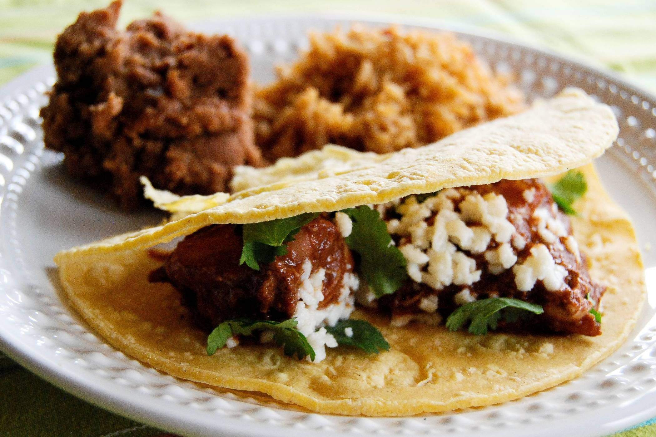 chicken mole taco on plate.