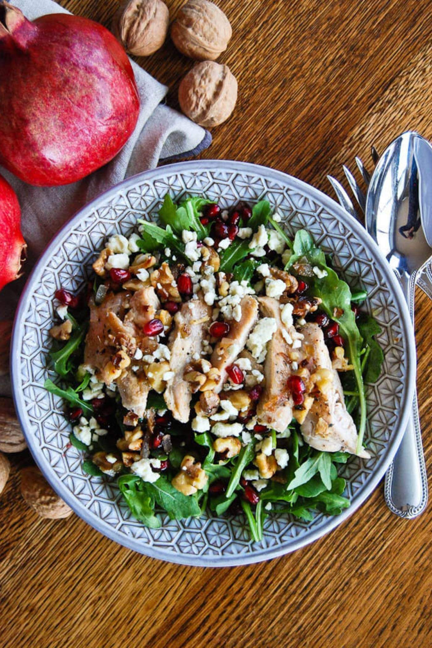 chicken pomegranate and arugula crunch salad in bowl.