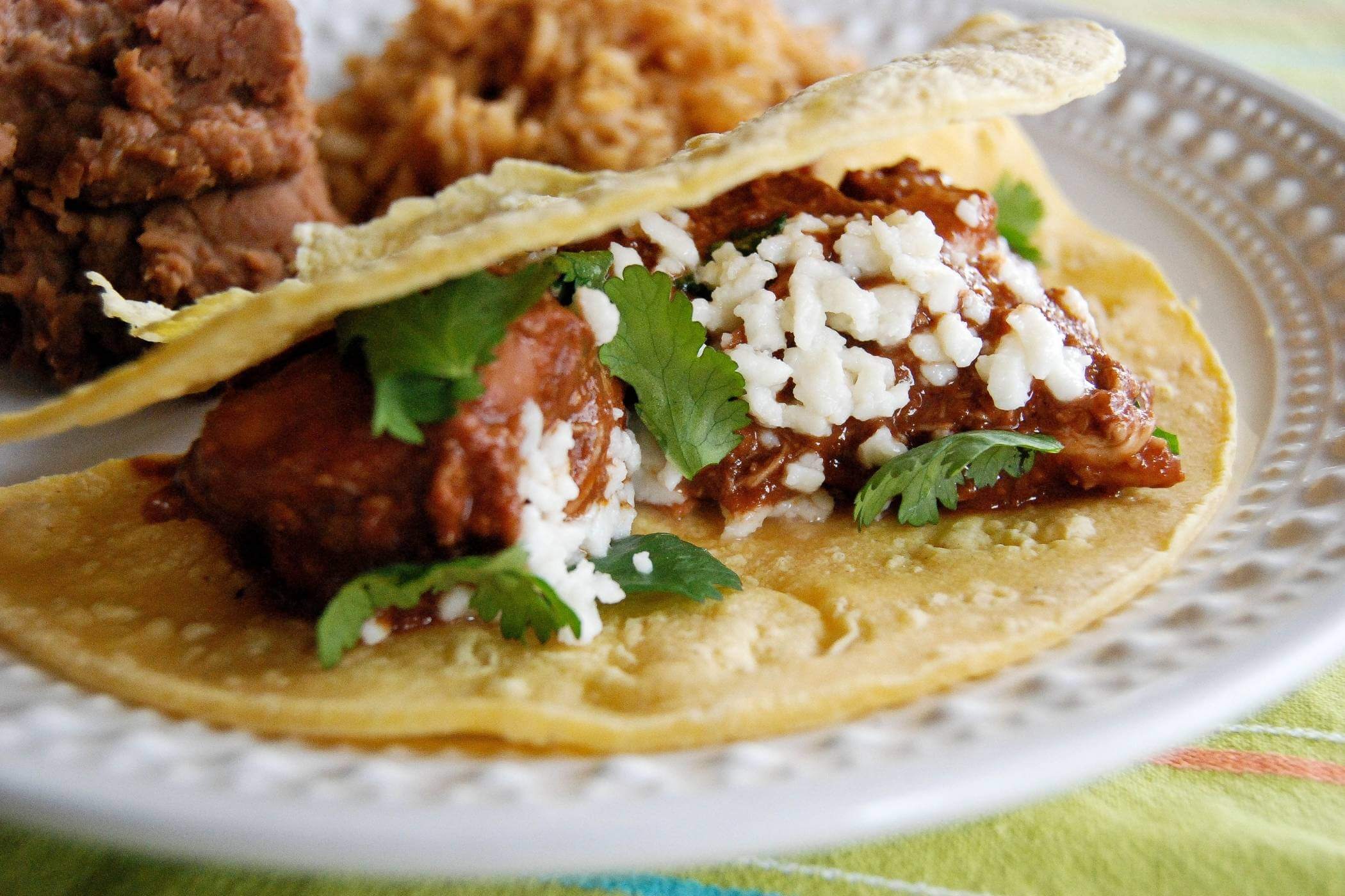 chicken mole taco on plate.