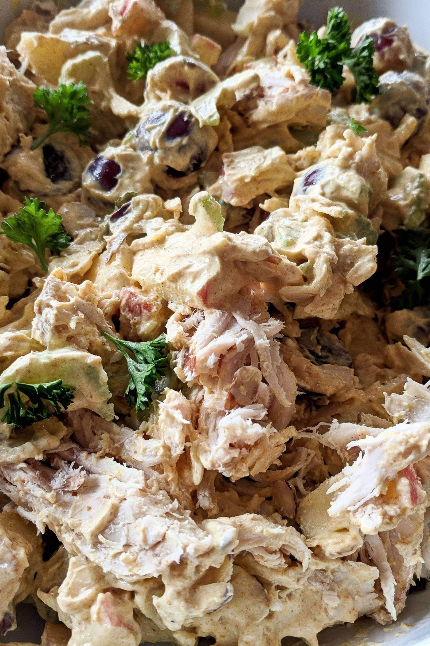 curry chicken salad with grapes in bowl.