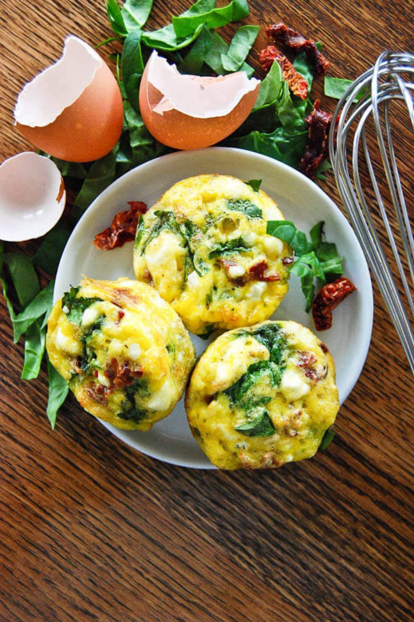 spinach feta and sun-dried tomato egg muffins on plate.