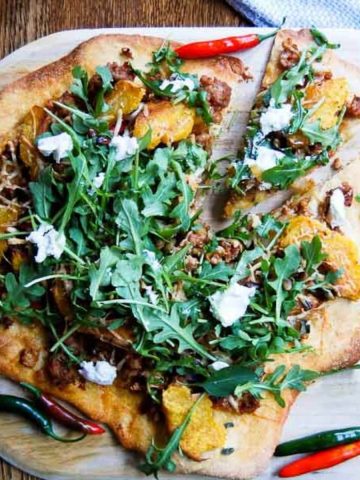 fall harvest pizza on cutting board