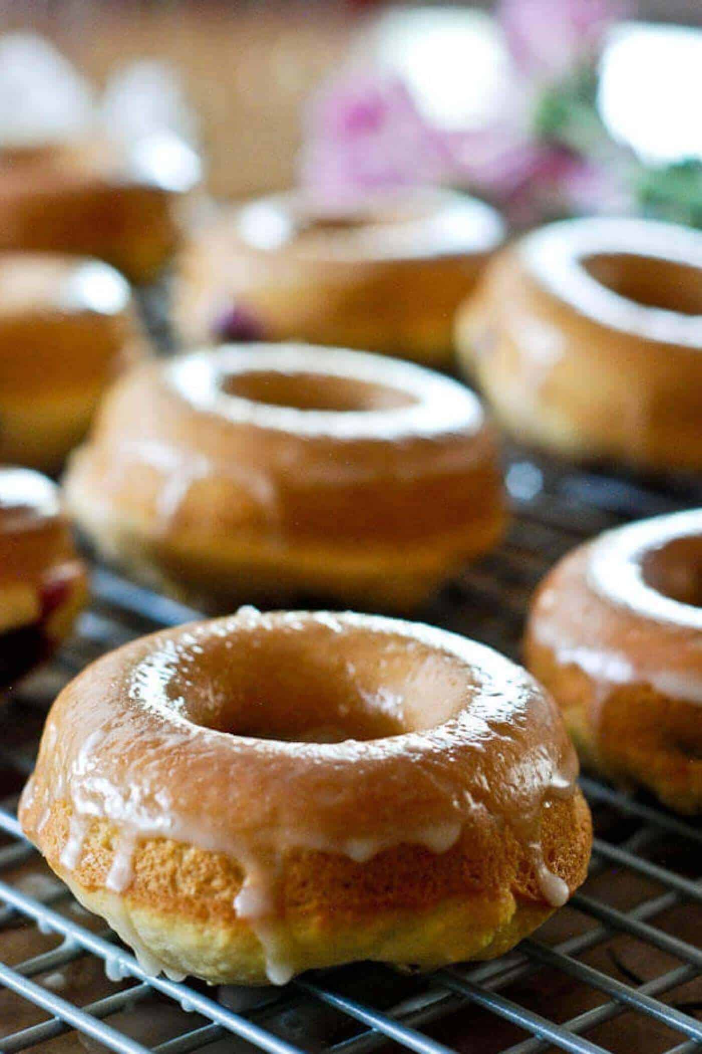 glazed lemon and blueberry baked donuts on cooking tray.