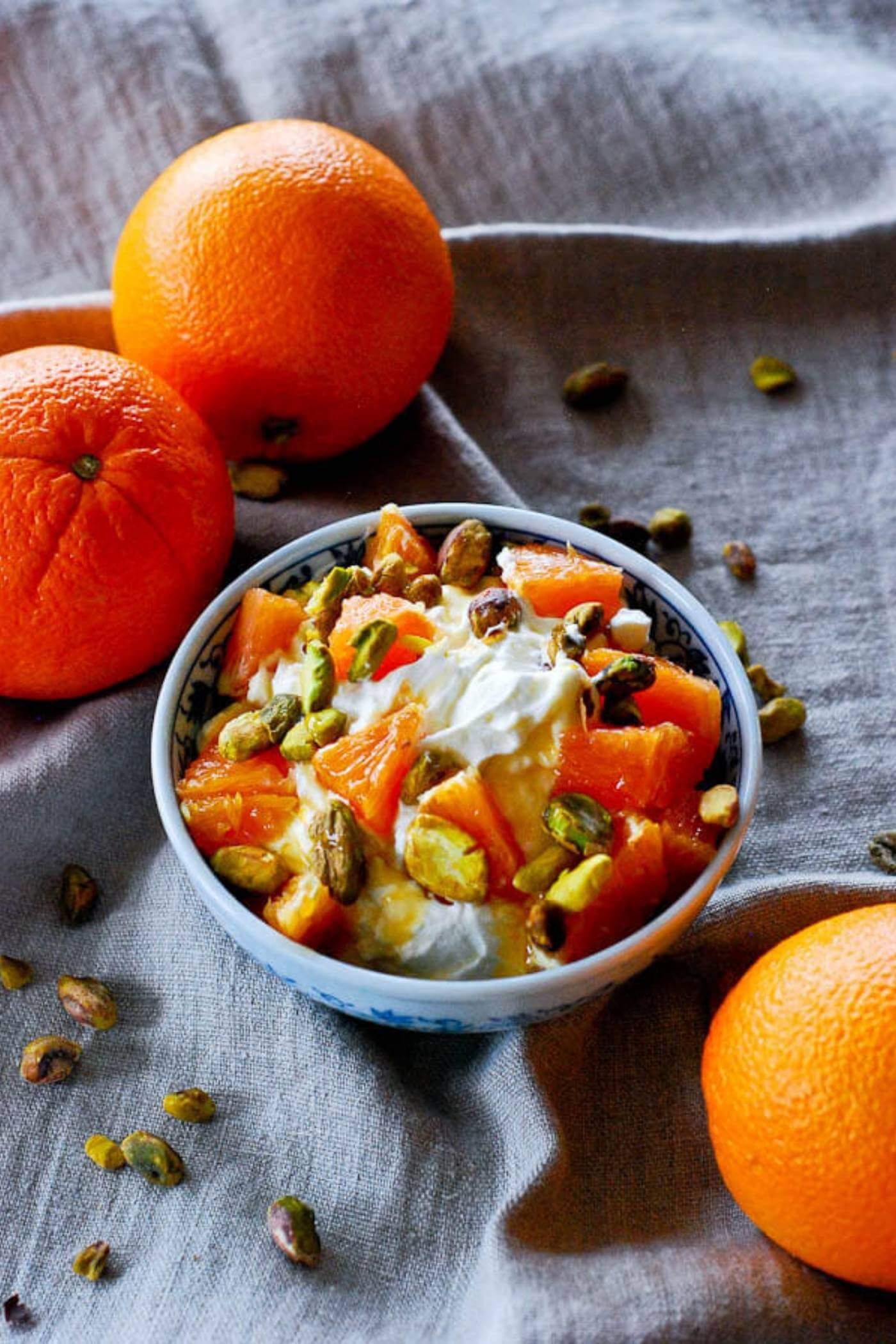 homemade creme fraiche citrus parfait in bowl with oranges.