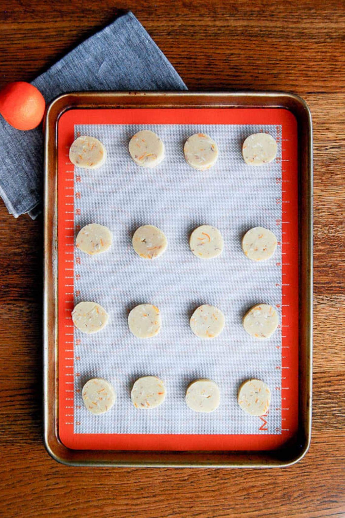 orange and almond shortbread cookies ready to bake on tray.