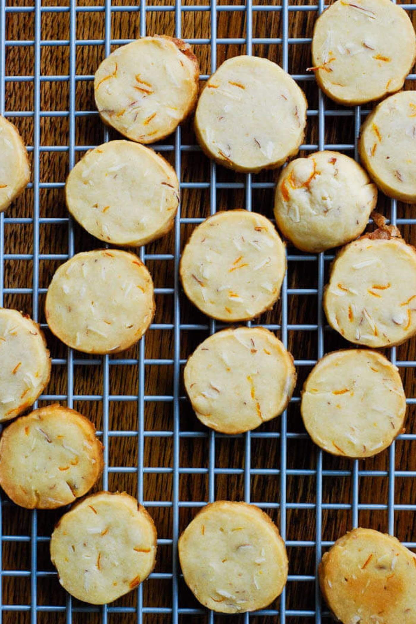 orange and almond shortbread cookies on cooling rack.