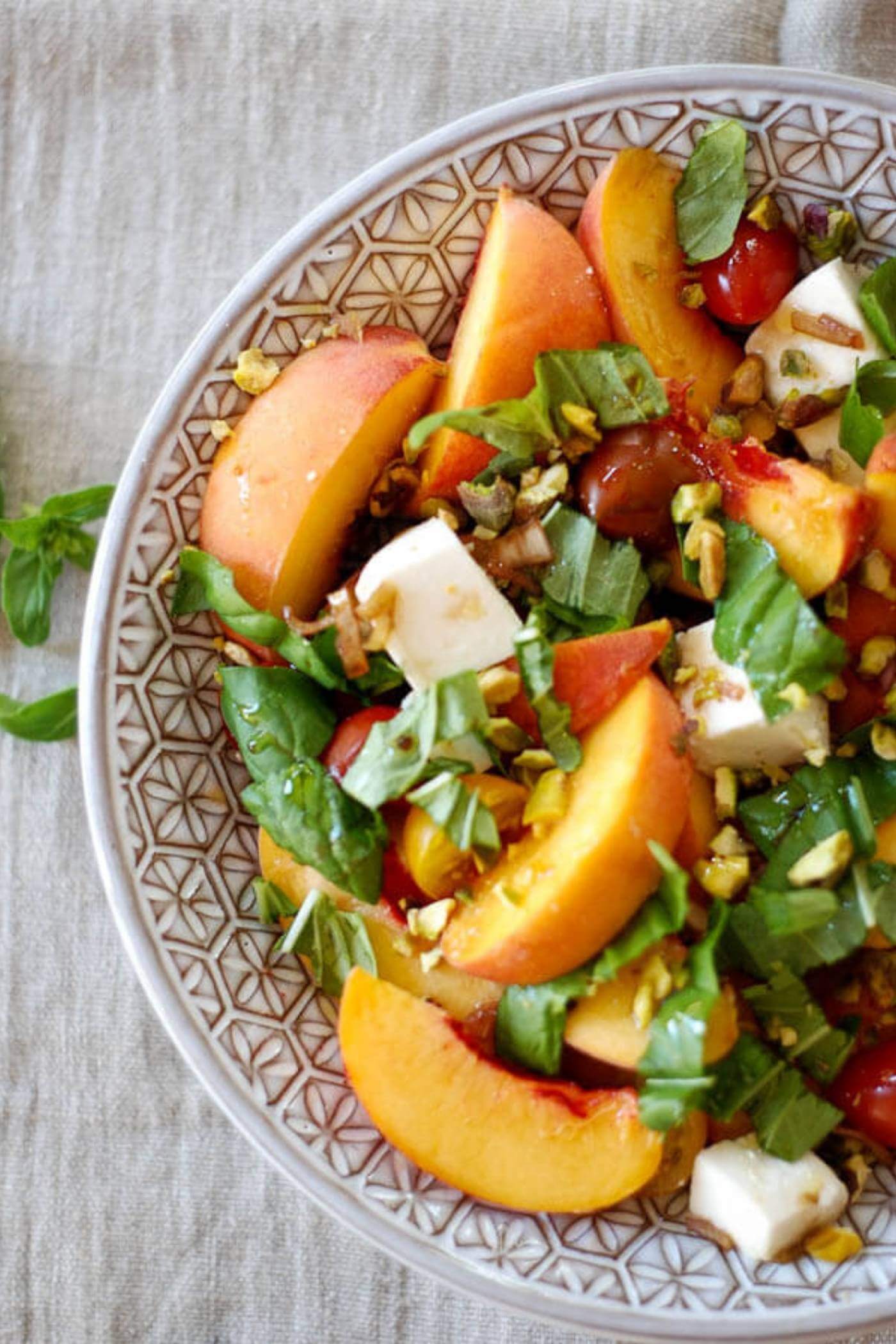 peach caprese salad in bowl.