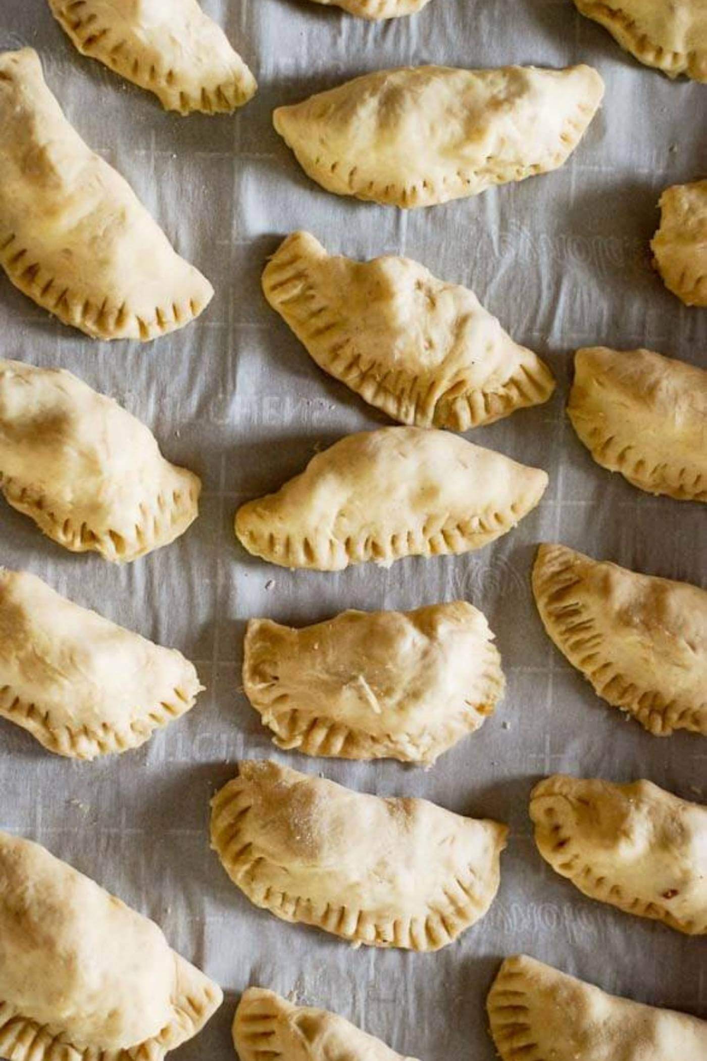 pear and cheddar hand pies on baking sheet.