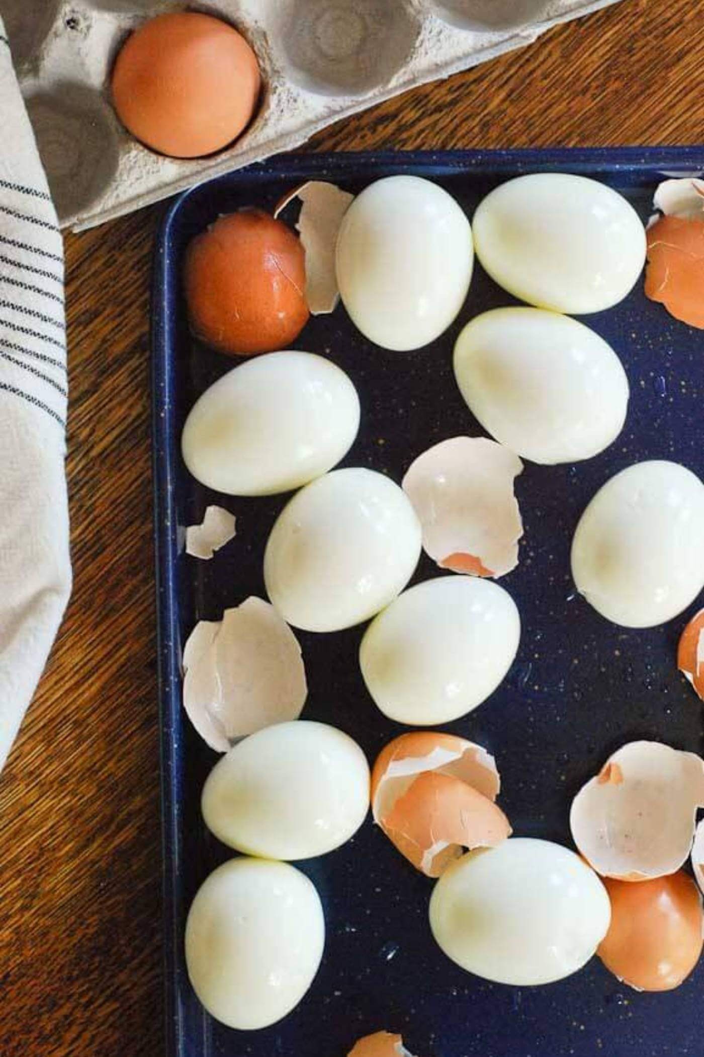 perfect instant pot hard boiled eggs peeled on tray.
