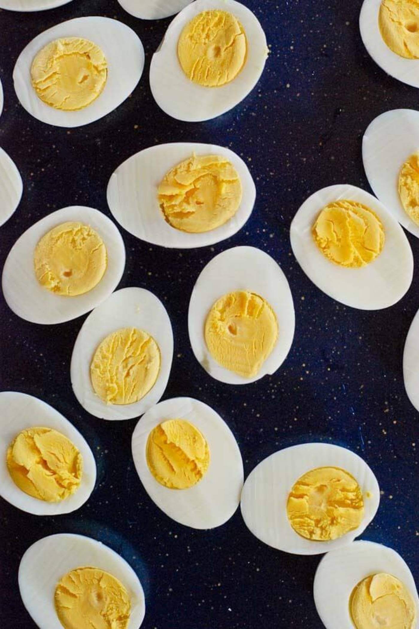 perfect hard boiled eggs from the instant pot, halved on tray.