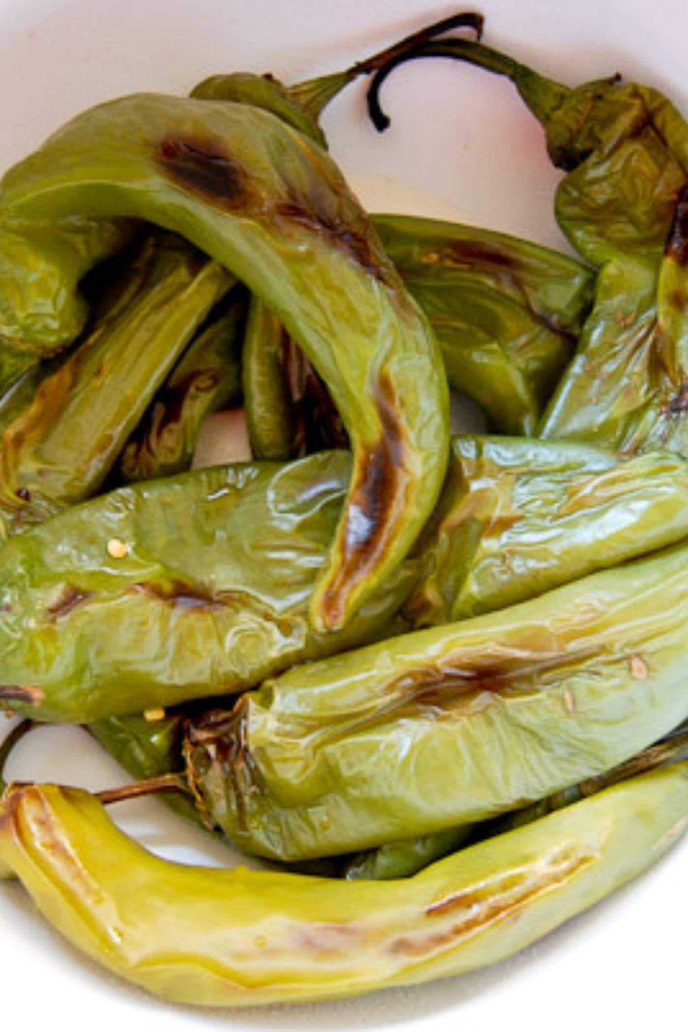 Roasted Hatch Chiles, unpeeled in bowl.