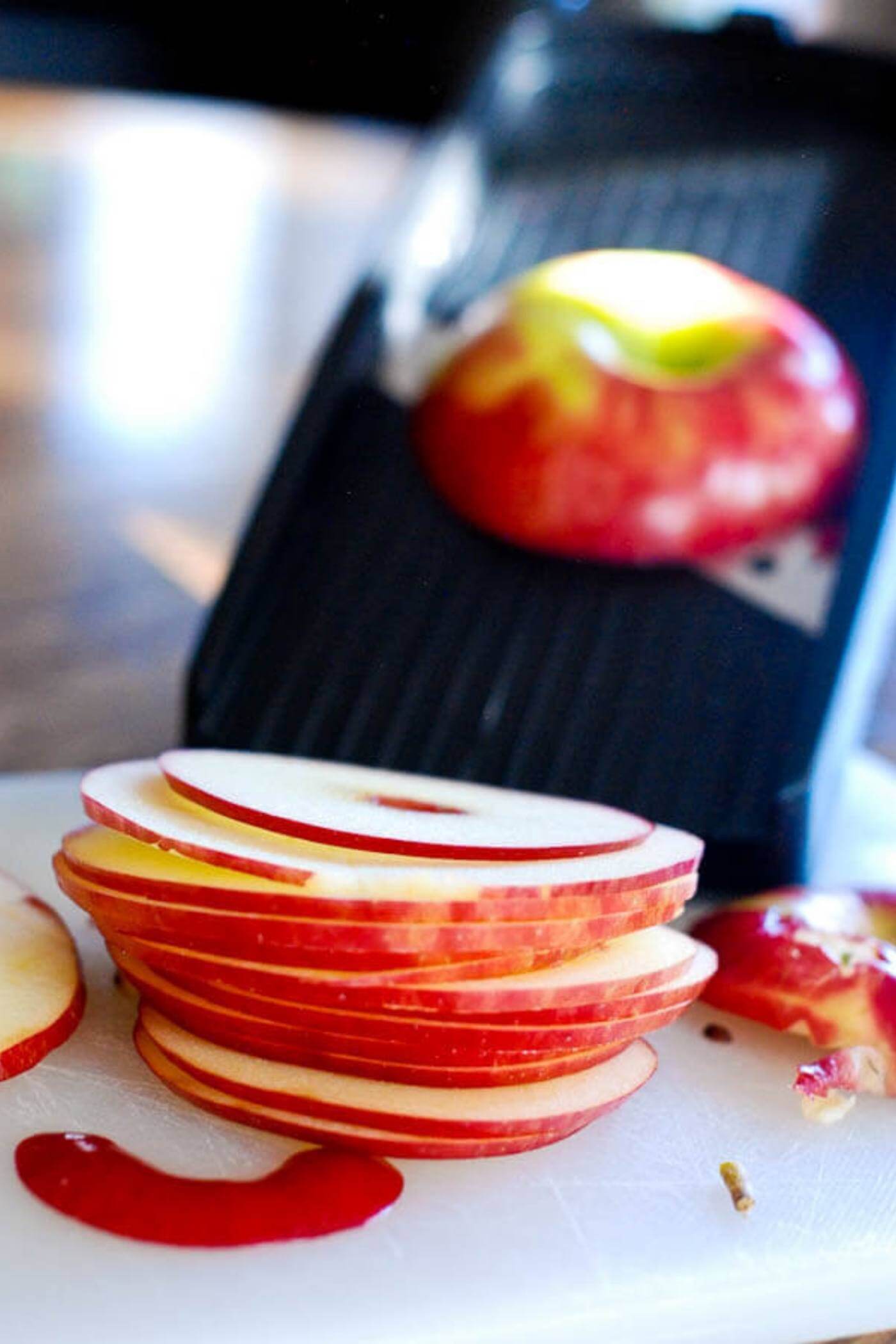 apple slices with a mandolin in the background.