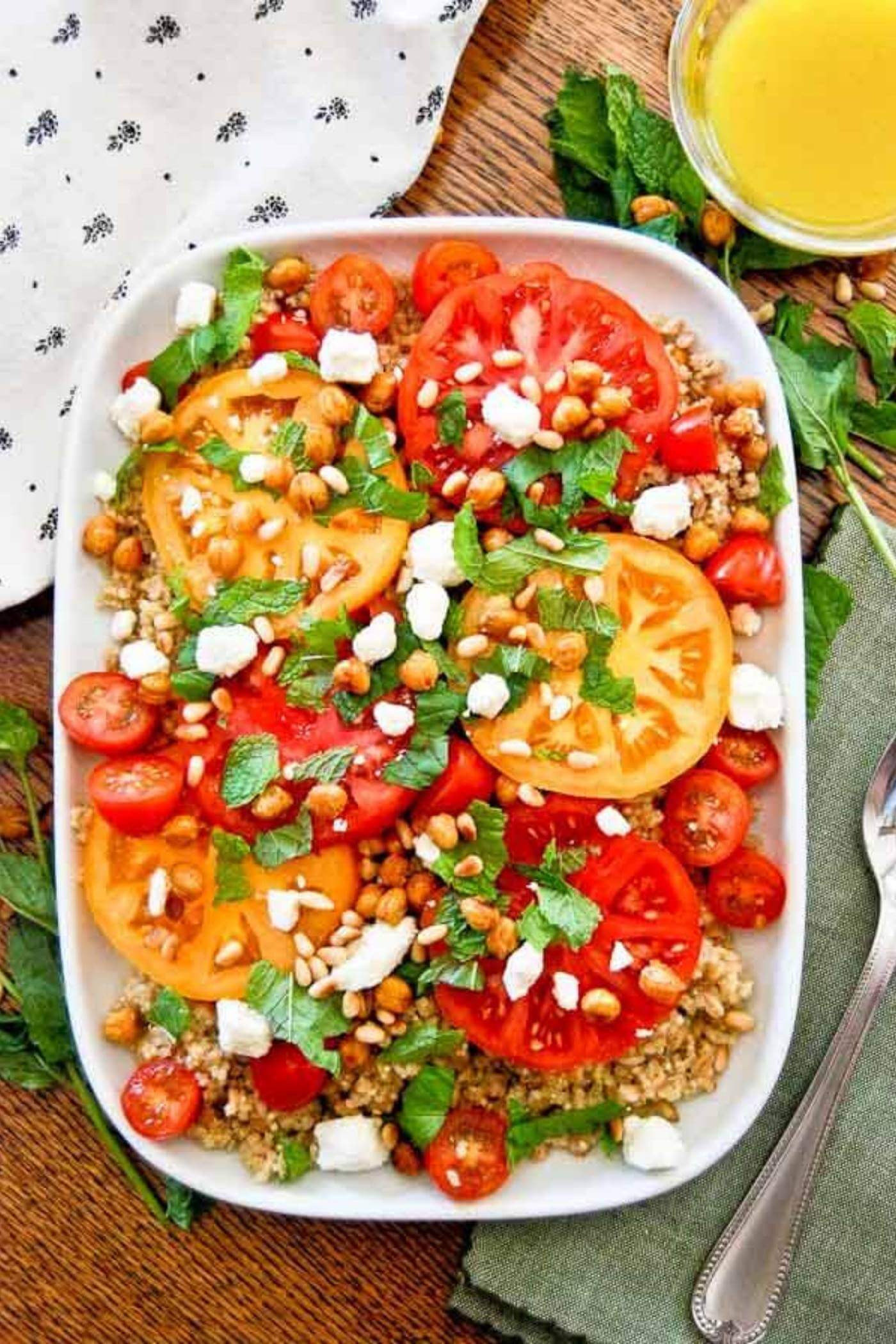 tomato grain mint and feta salad on serving platter.