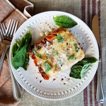 easy vegetable lasagna on plate with basil and parmesan
