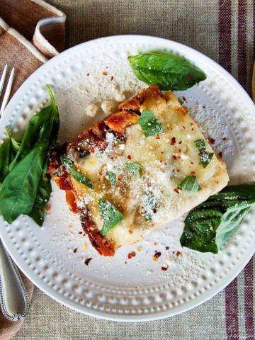 easy vegetable lasagna on plate with basil and parmesan