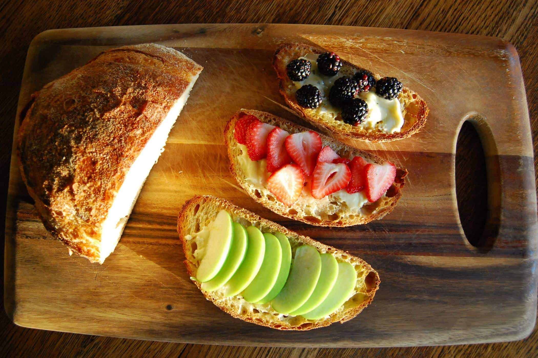 cheese fruit and honey bruschetta on cutting board.