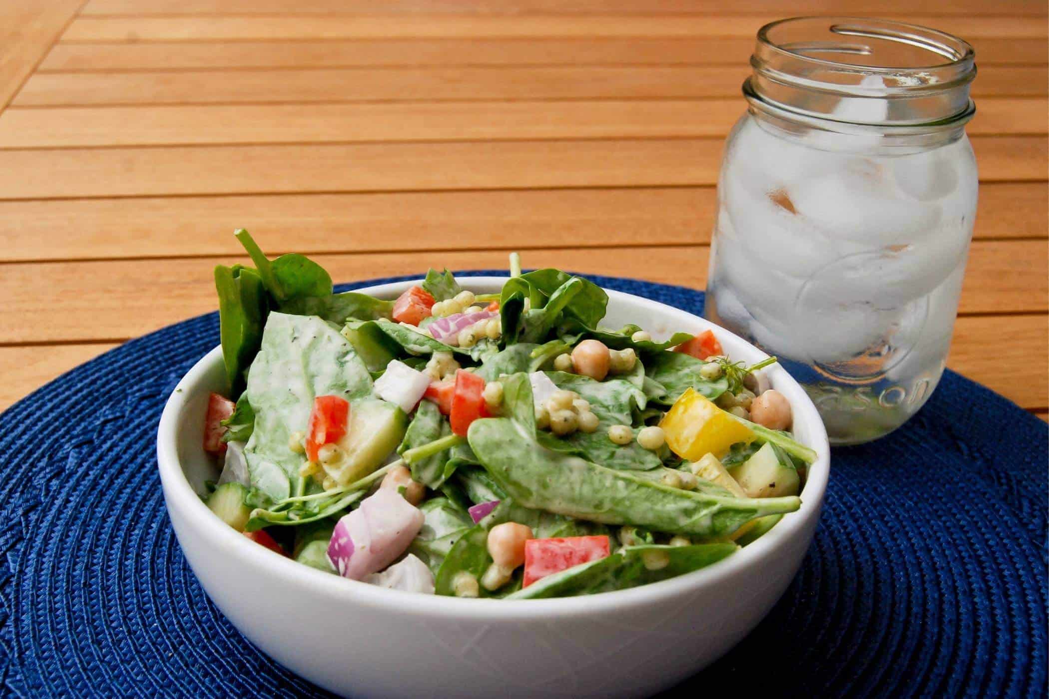 chickpea and veggie salad with dill dressing in bowl.