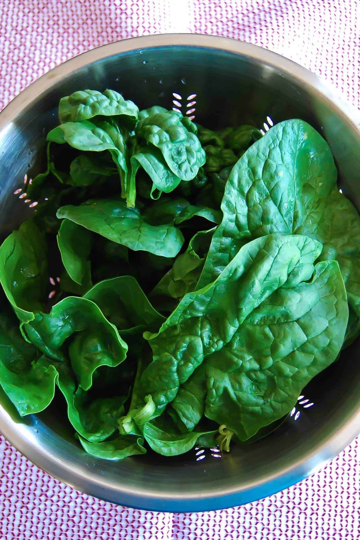 fresh spinach in colander.