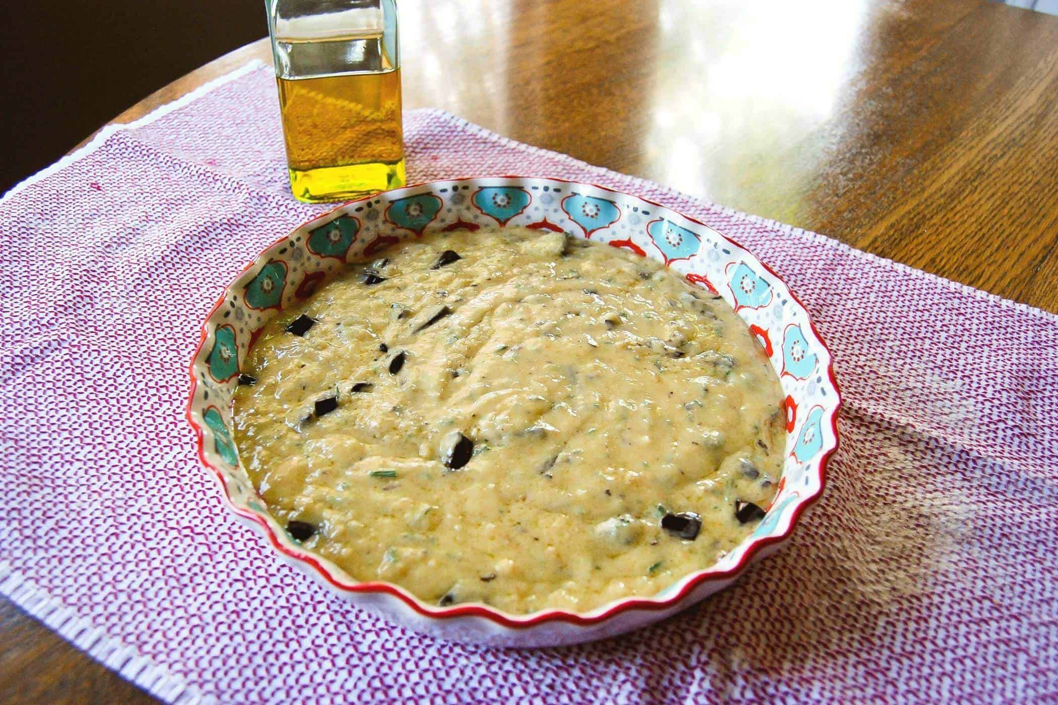 olive oil and rosemary cake with chocolate in baking dish.