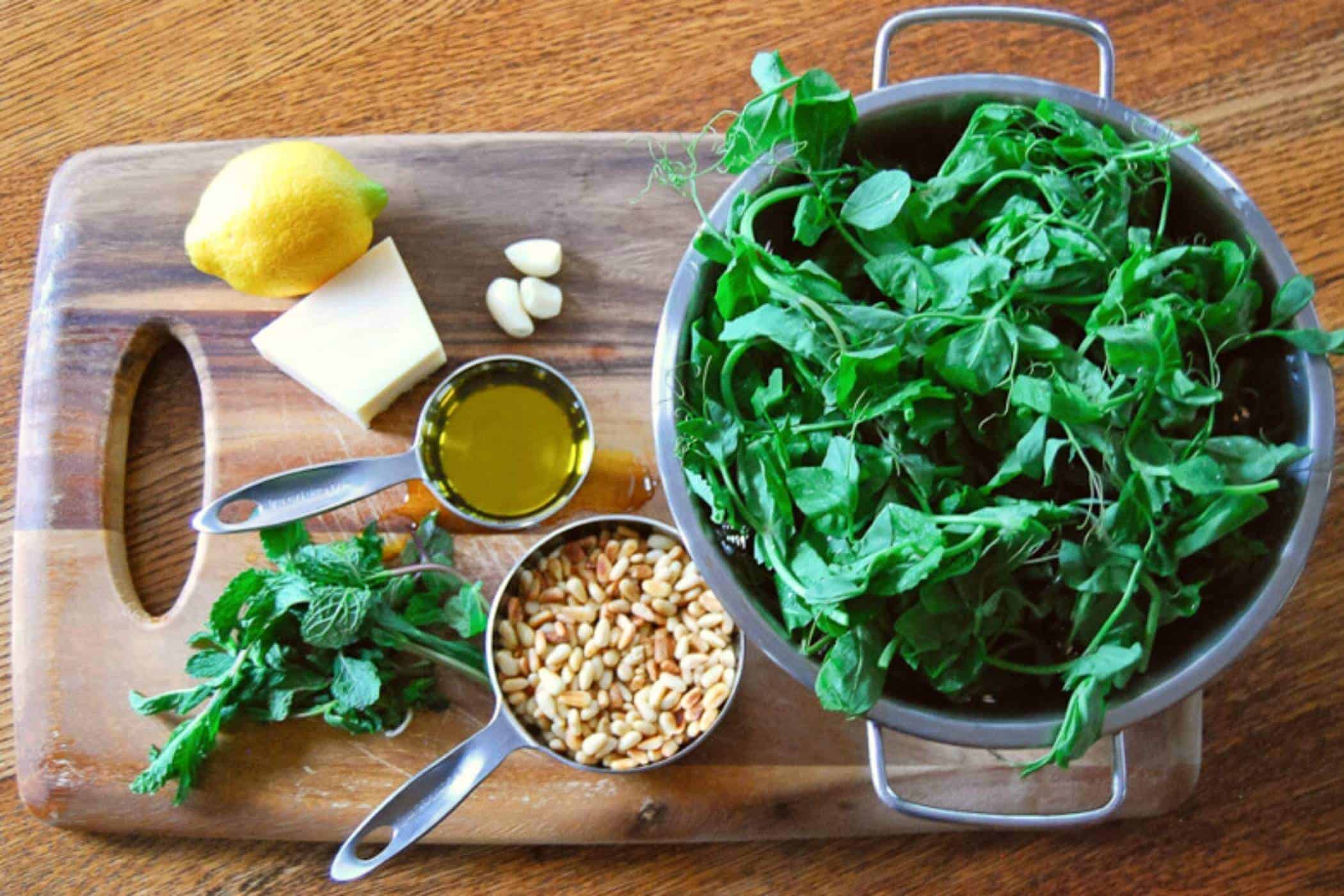 pesto ingredients on a cutting board.